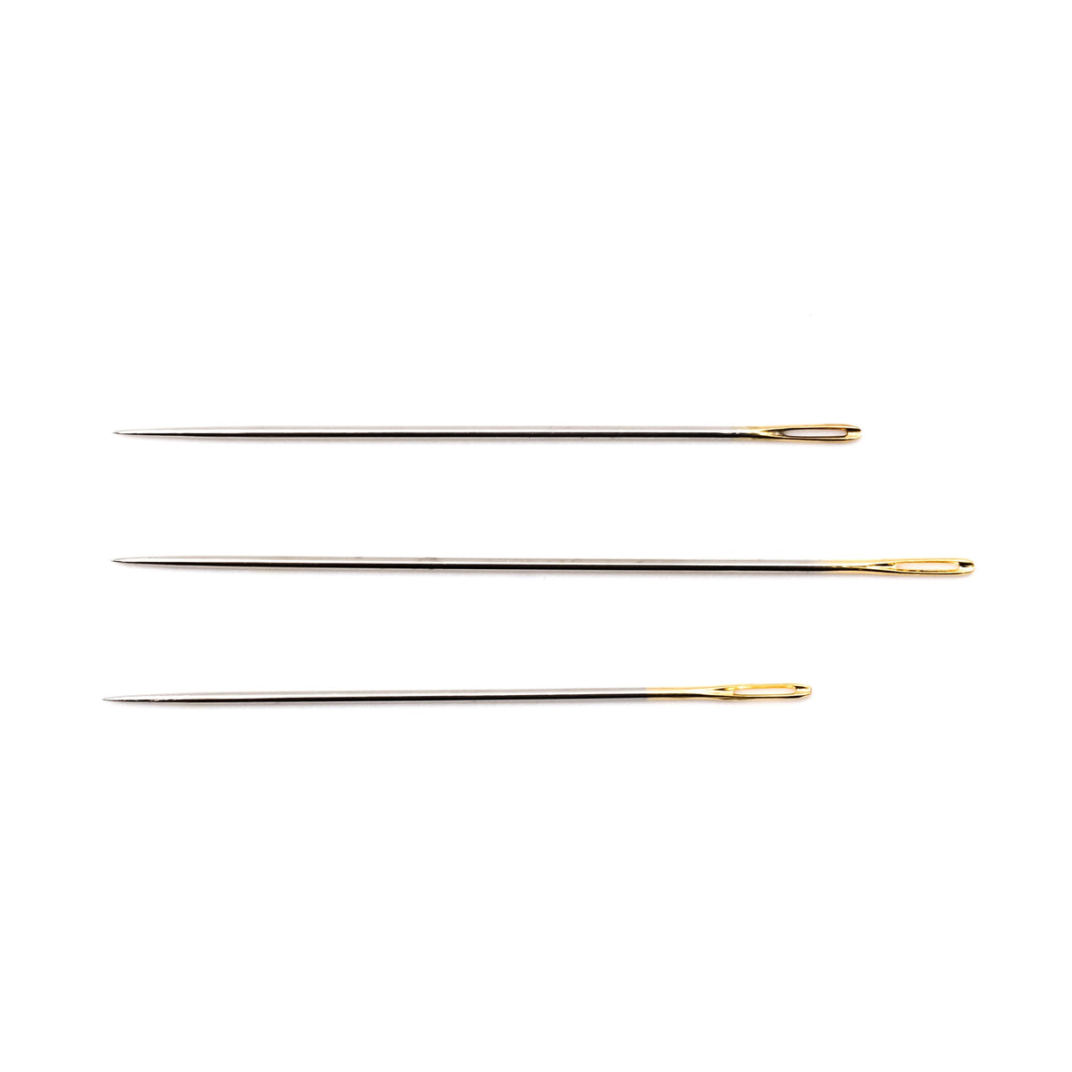 Three long Clover sashiko needles laid side by side on a white background, each with a gold-plated eye.