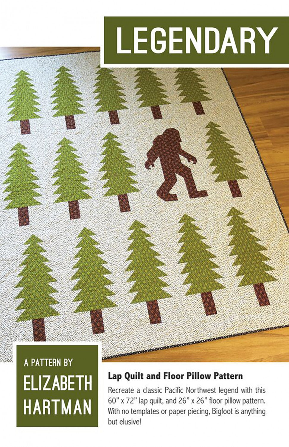Legendary quilt pattern cover by Elizabeth Hartman. The 60 by 72 inch lap quilt is displayed on a wood floor, showing a single large brown patchwork Bigfoot silhouette mid-stride among 14 tall patchwork pine trees with brown trunks on a speckled cream background with dark binding.