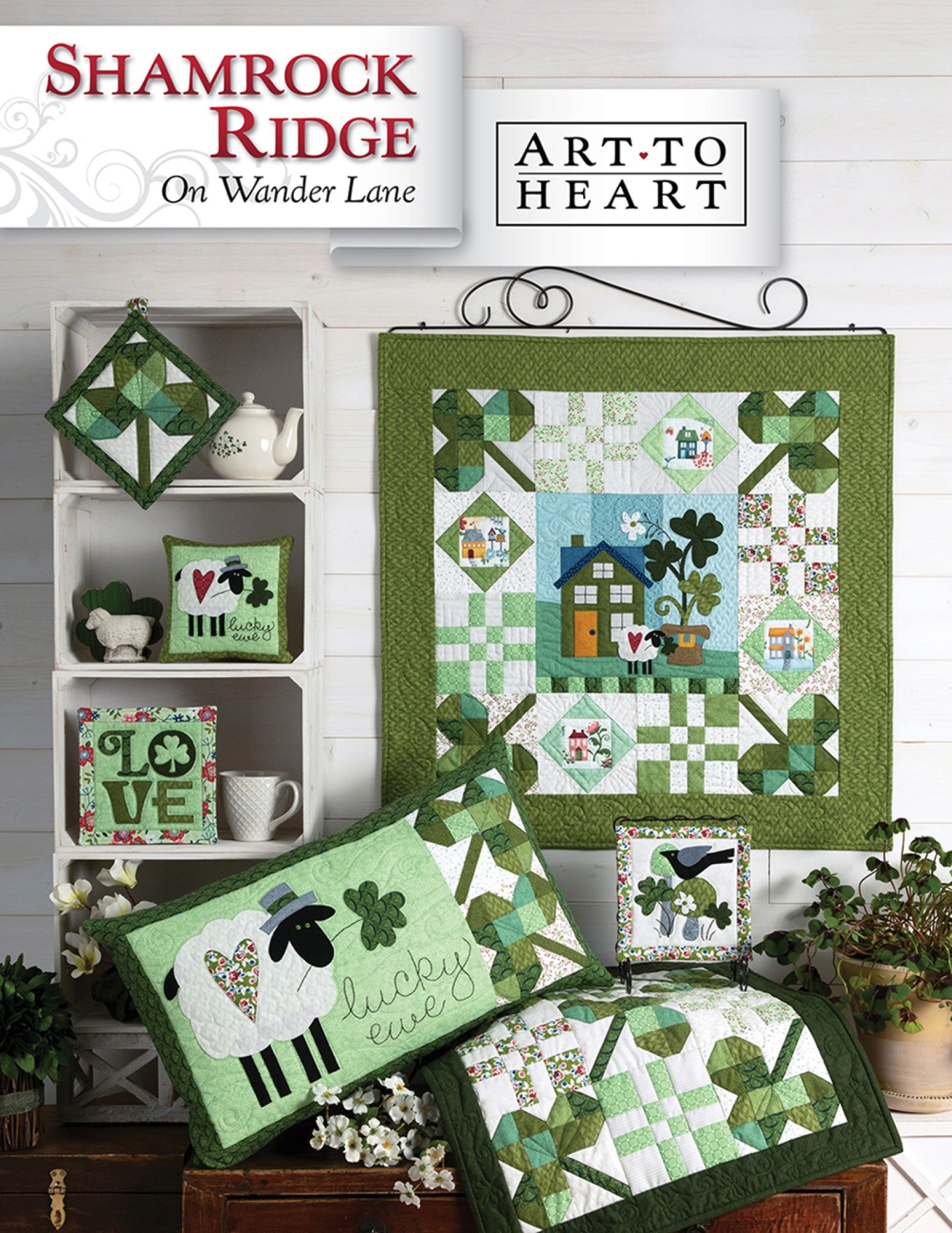 Front cover of the Shamrock Ridge on Wander Lane quilt pattern by Nancy Halvorsen, Art to Heart, showing the shamrock and sheep appliqué block framed in patchwork with a Lucky Ewe pillow and green St. Patrick's Day projects.