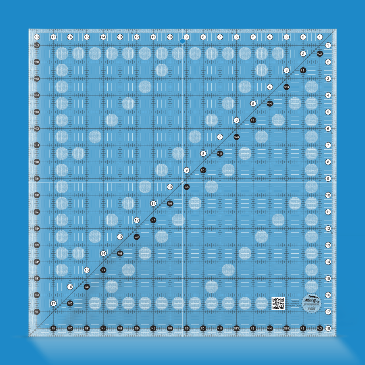 Creative Grids 18-1/2 inch square quilt ruler CGR1818 by Rachel Cross rendered in translucent blue acrylic with black and white grid markings, whole-inch numbers in white dots, half-inch Turn-a-Round numbers in black dots, a 45 degree diagonal, a 1/4 inch dashed seam line, and white centering lines.