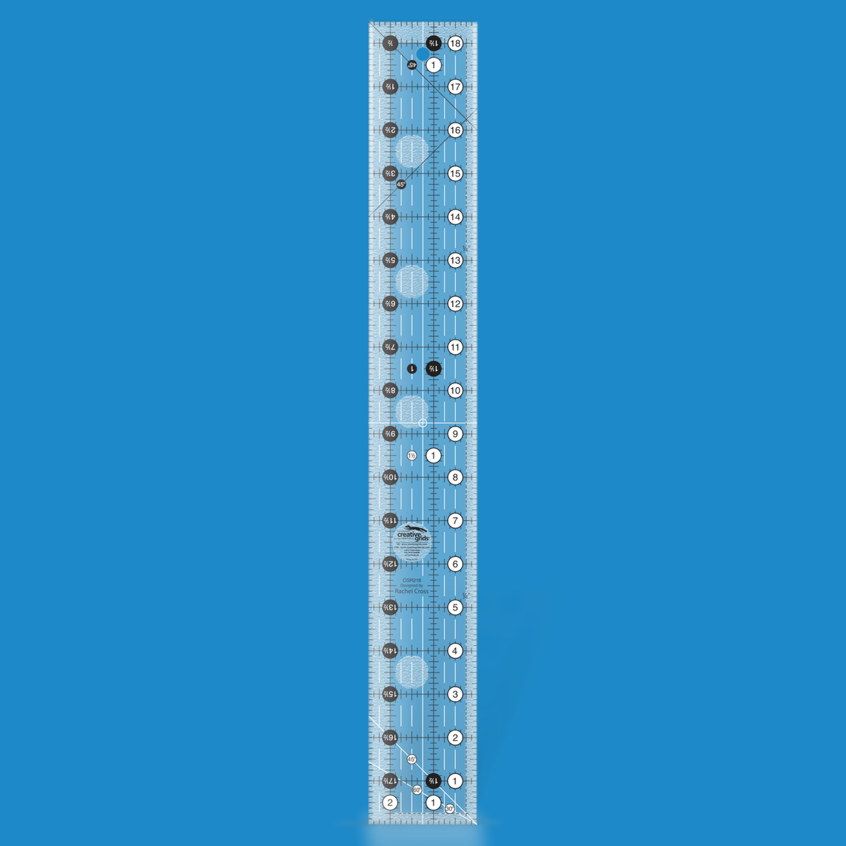 Creative Grids 2-1/2 x 18-1/2 inch rectangle quilt ruler CGR218 by Rachel Cross rendered in translucent blue acrylic with black and white grid markings, whole-inch numbers in white dots, half-inch Turn-a-Round numbers in black dots, crossed 45 degree lines, a 30/60 degree line, a 1/4 inch dashed seam line, and white centering lines.