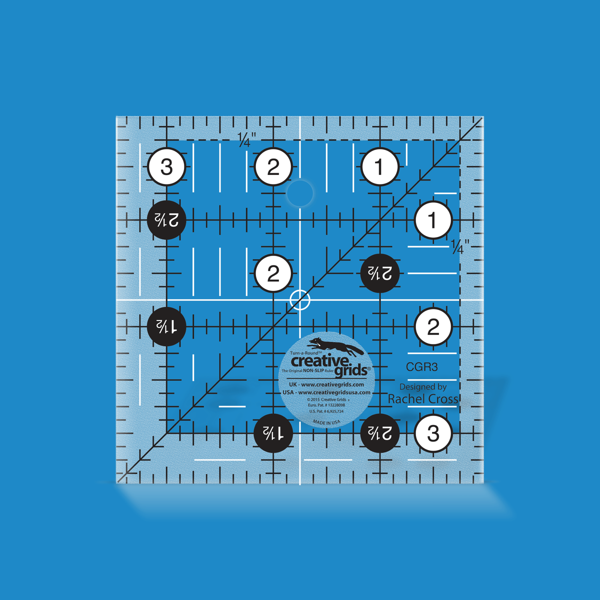 Creative Grids 3-1/2 inch square quilt ruler CGR3 by Rachel Cross rendered in translucent blue acrylic with black and white grid markings, whole-inch numbers in white dots, half-inch Turn-a-Round numbers in black dots, a 45 degree diagonal, a 1/4 inch dashed seam line, and white centering lines.