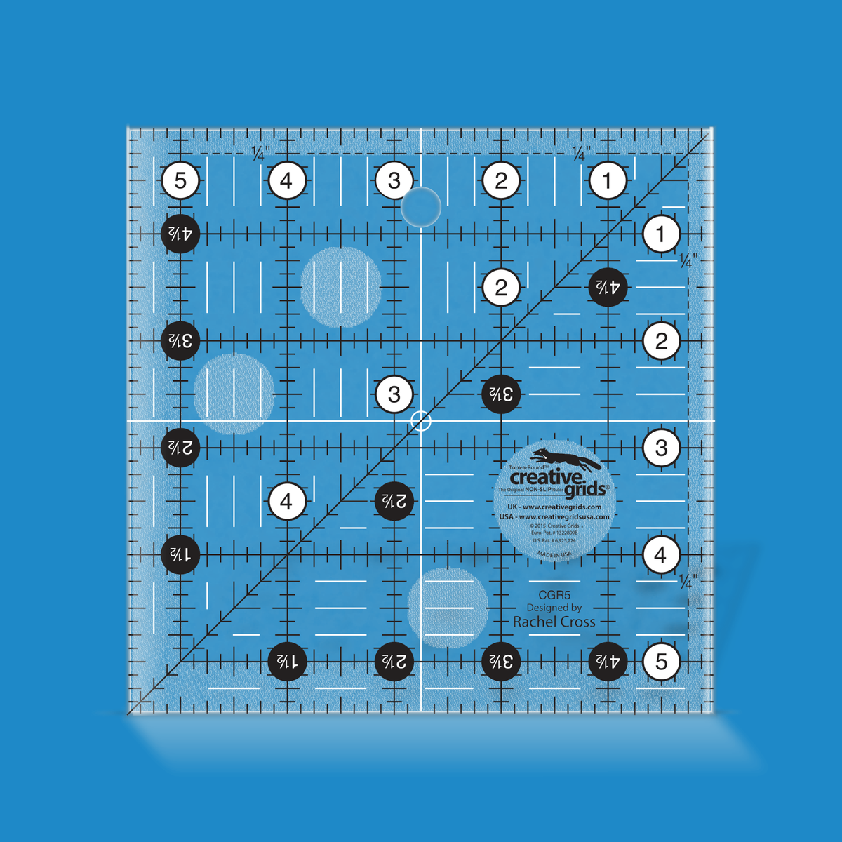 Creative Grids 5-1/2 inch square quilt ruler CGR5 by Rachel Cross rendered in translucent blue acrylic with black and white grid markings, whole-inch numbers in white dots, half-inch Turn-a-Round numbers in black dots, a 45 degree diagonal, a 1/4 inch dashed seam line, and white centering lines.