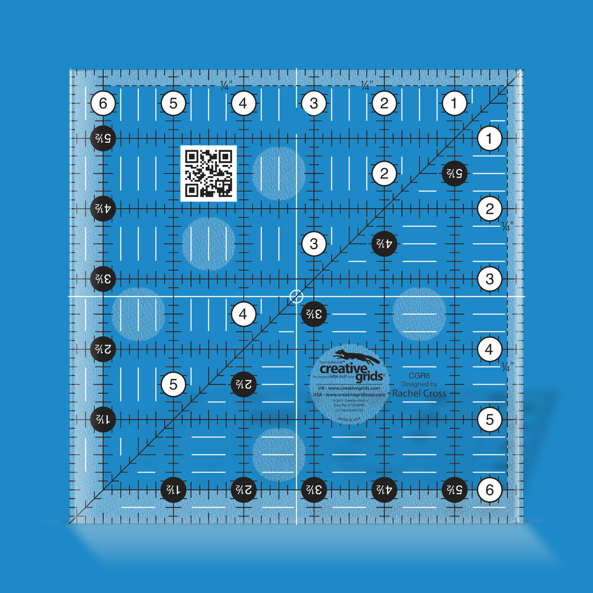 Creative Grids 6-1/2 inch square quilt ruler CGR6 by Rachel Cross rendered in translucent blue acrylic with black and white grid markings, whole-inch numbers in white dots, half-inch Turn-a-Round numbers in black dots, a 45 degree diagonal, a 1/4 inch dashed seam line, and white centering lines.