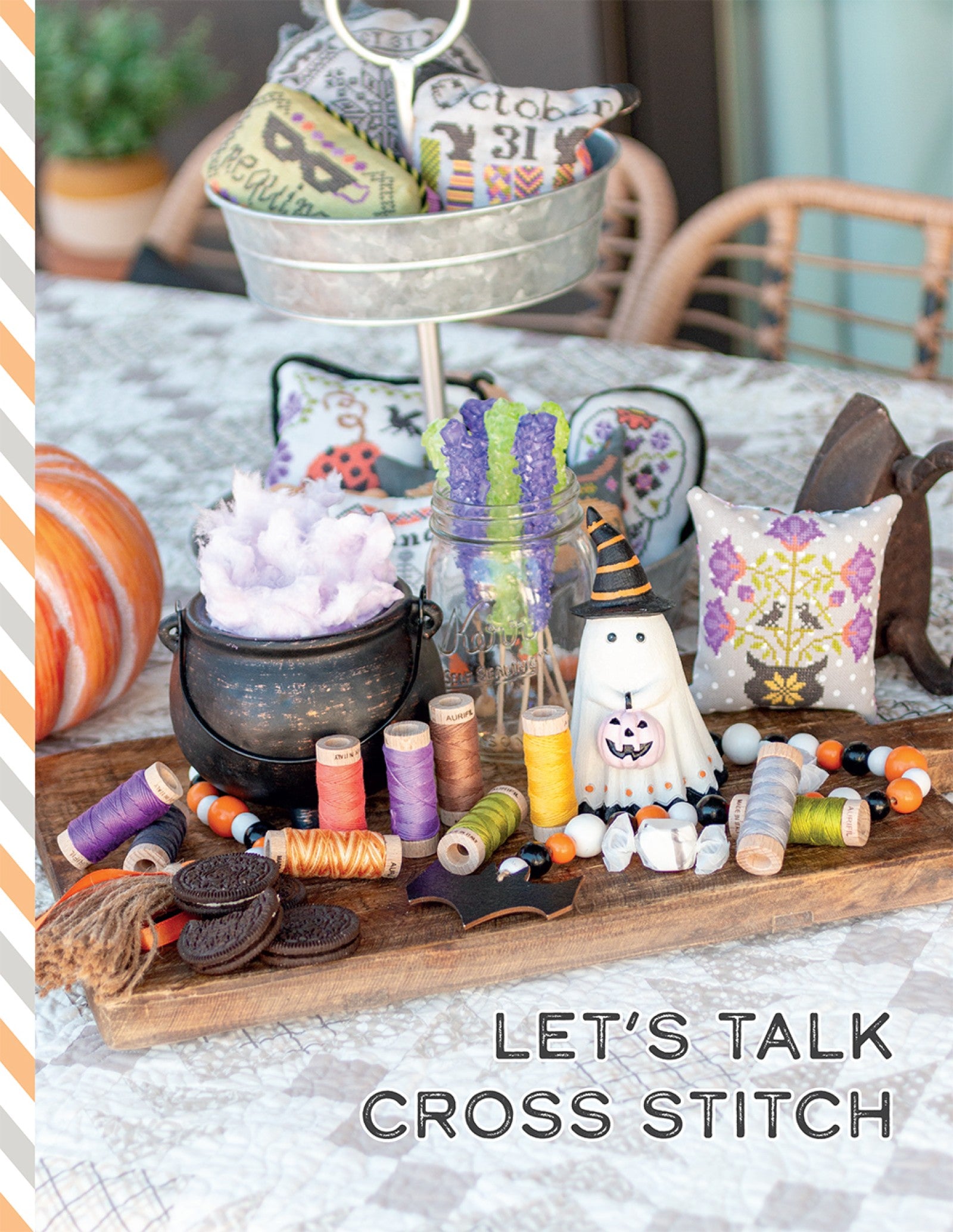 The Let's Talk Cross Stitch section of Halloween Memories, styled with a cauldron, floss, and a stitched cushion.