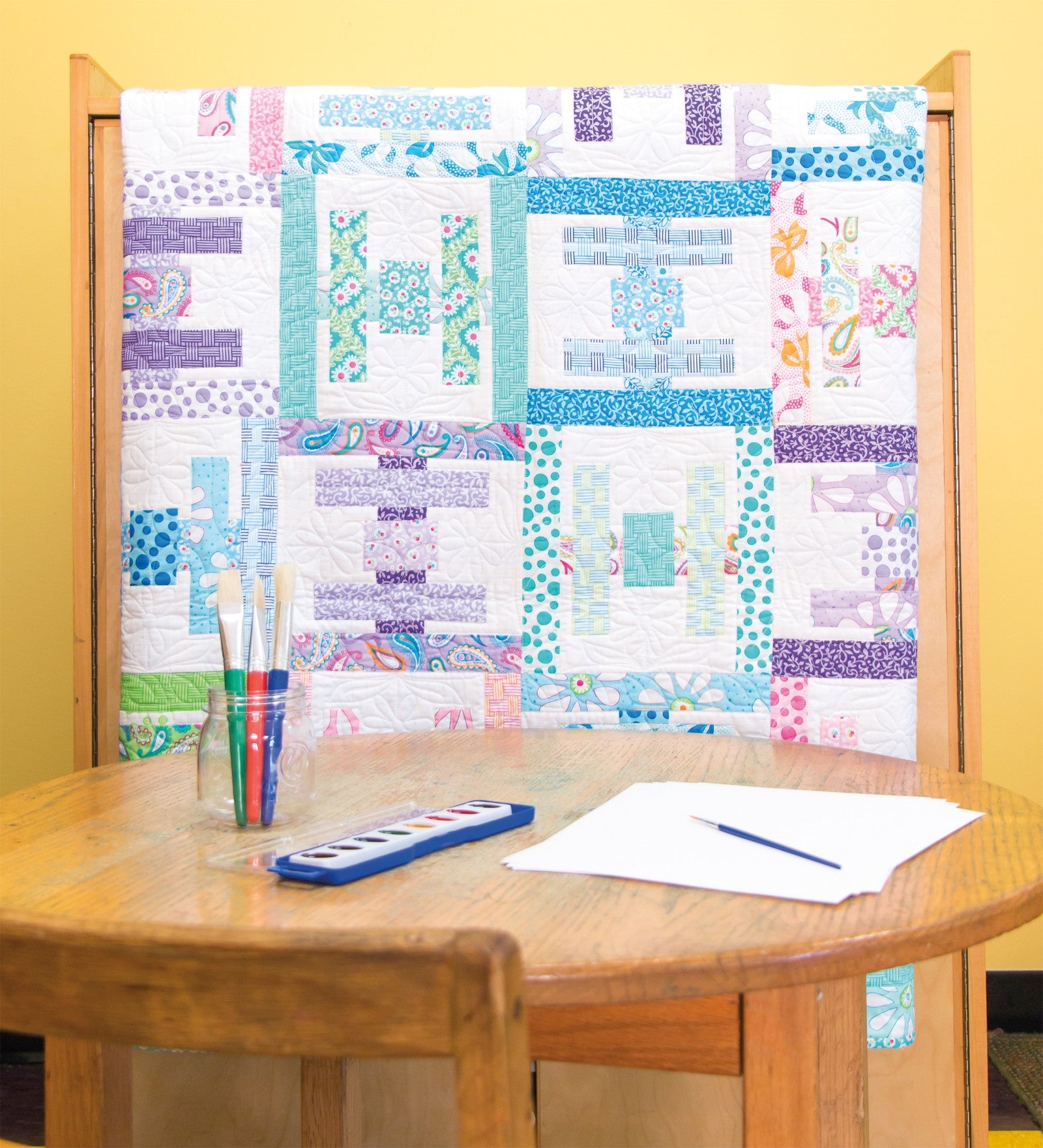 Interior quilt from Precut Primer, rail and rectangle blocks in soft prints with white sashing.