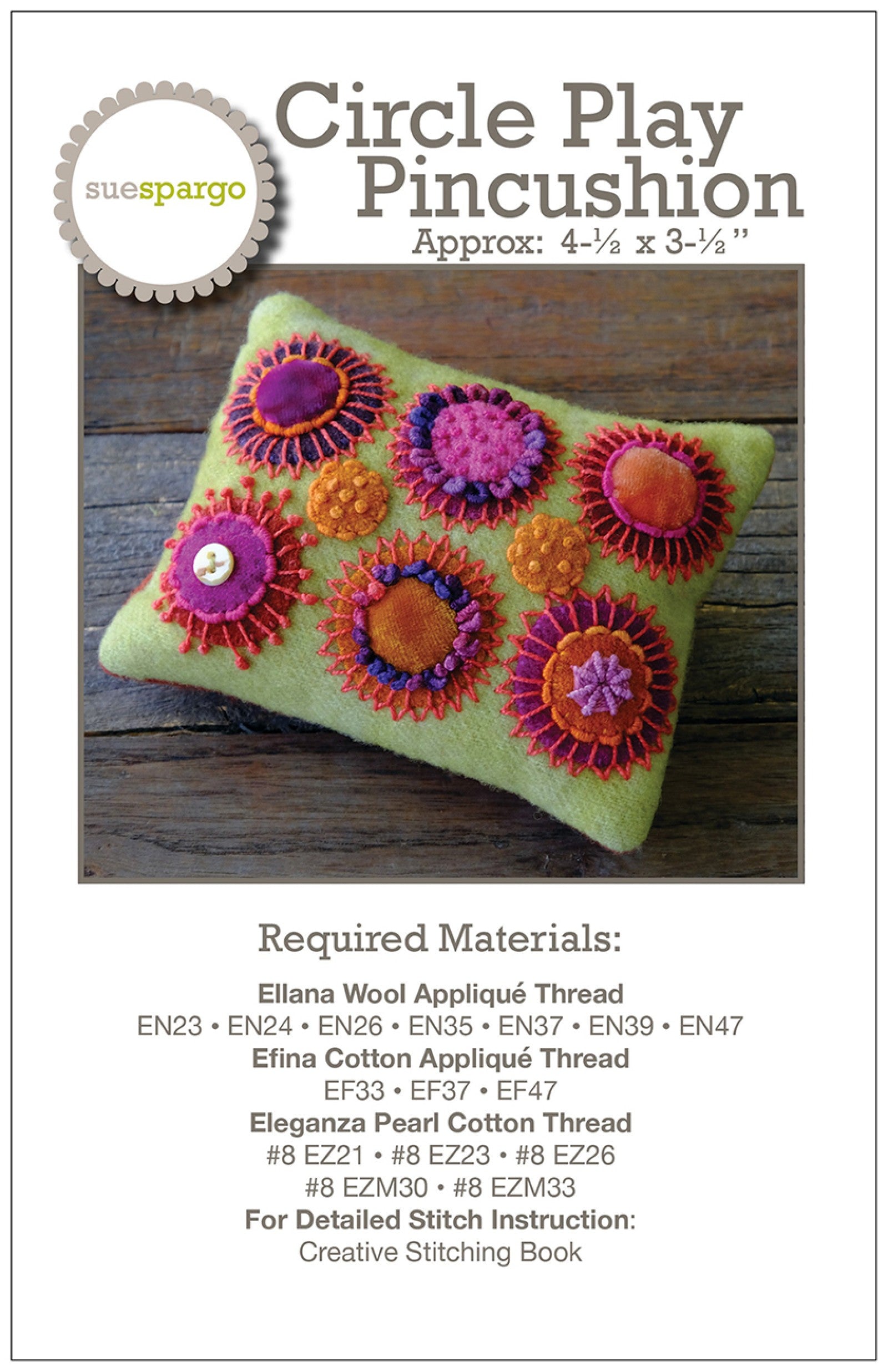Circle Play Pincushion sewing pattern by Sue Spargo of Folk Art Quilts. Front cover shows a green wool pincushion covered in layered wool and velvet circles in pink, orange, purple, and red, each ringed with colorful hand embroidery, on rustic wood. Thread list printed below.