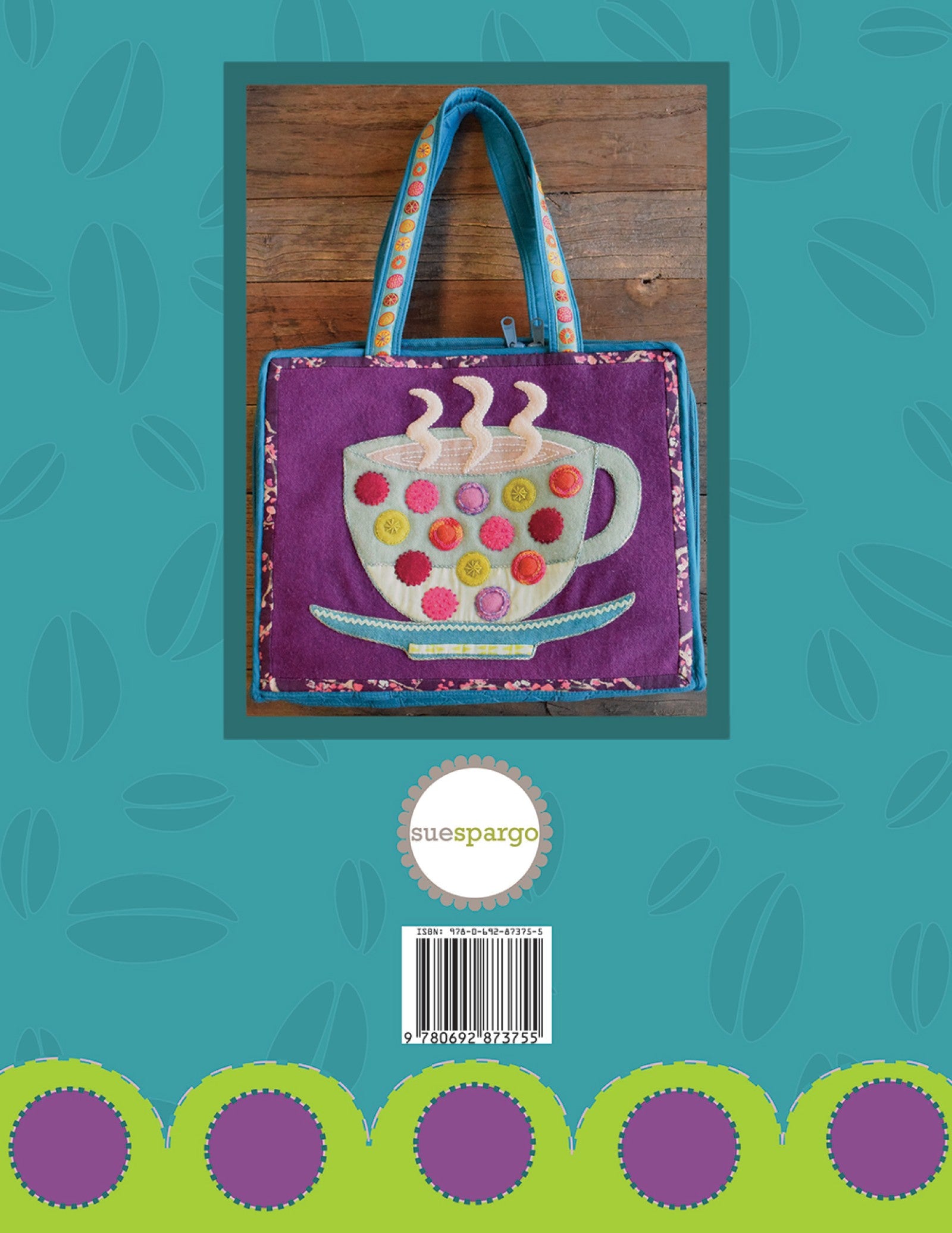Back cover of Cuppa by Sue Spargo of Folk Art Quilts, showing the bonus Cuppa Workbox, a fabric project bag with a large applique cup and button accents on purple, on a coffee-bean patterned ground with the Sue Spargo logo and barcode.