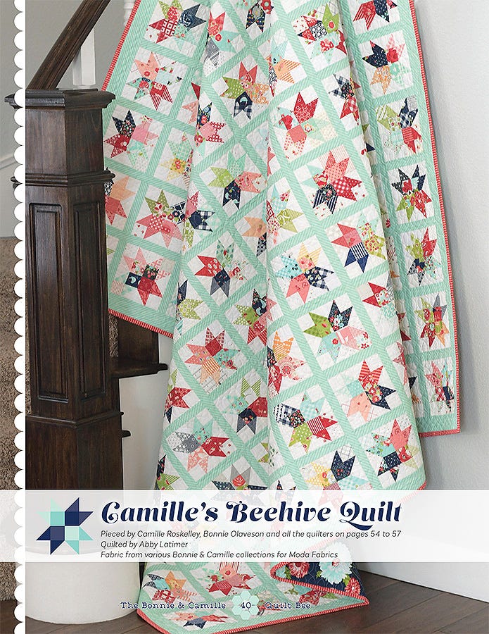 Camille's Beehive Quilt from The Bonnie & Camille Quilt Bee, aqua and coral star blocks on a white background.