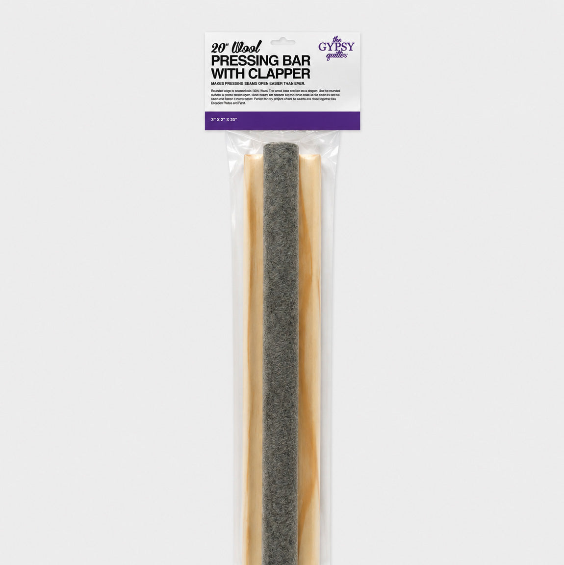 The Gypsy Quilter 20-inch Wool Pressing Bar with Clapper in its retail package, the printed header card showing the product name, brand logo, and 3 by 2 by 20 inch size above the gray wool bar and light wood base visible through the clear packaging.