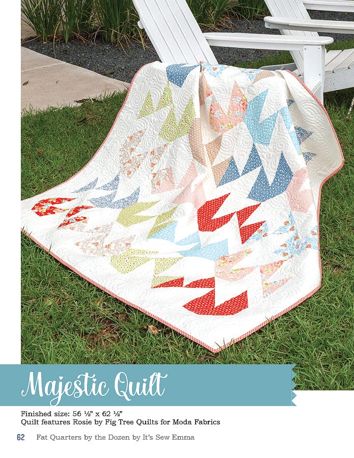 The Majestic quilt, 56.5 x 62.5 inches, soft aqua and coral pieced blocks draped over a porch chair.