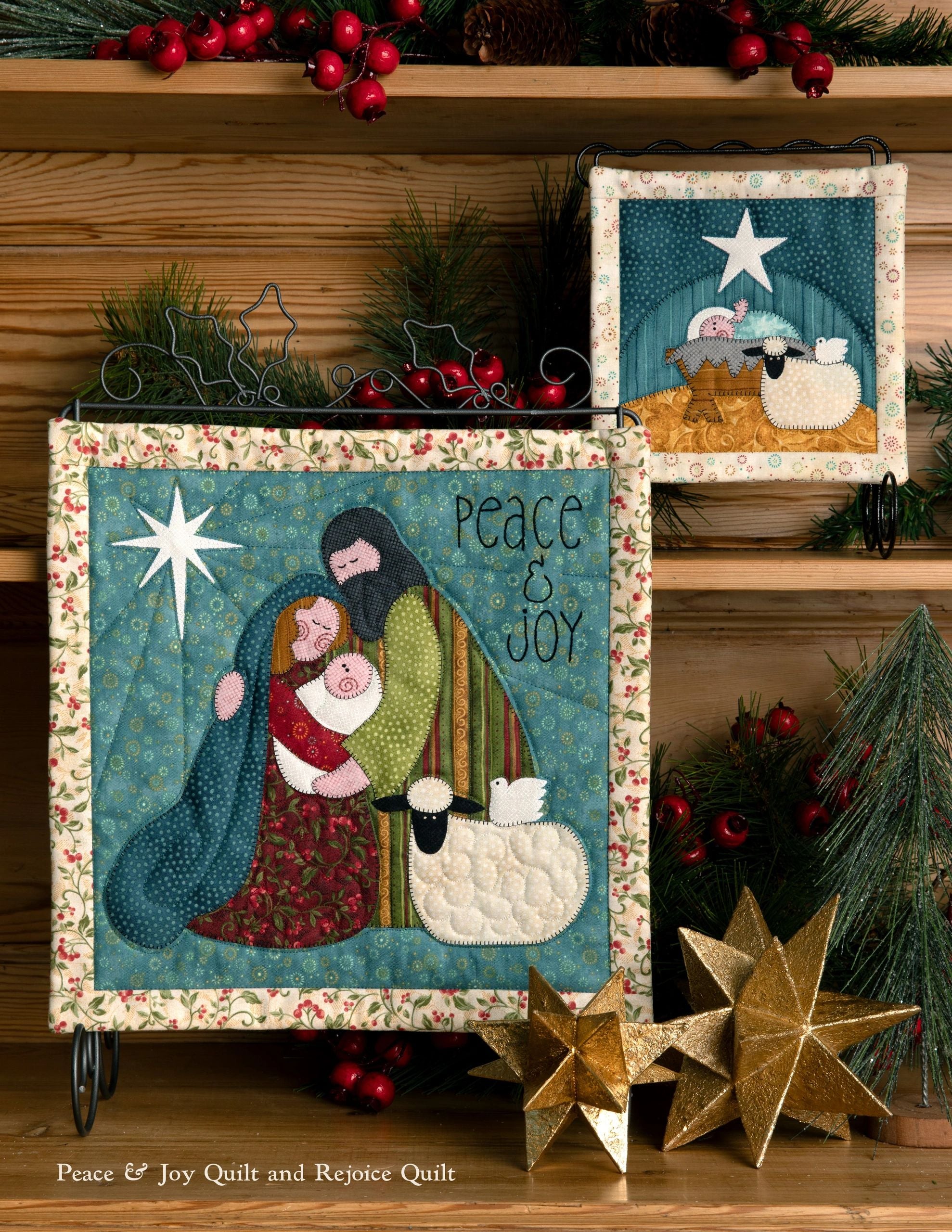 Interior page of the Good Cheer quilt pattern book by Nancy Halvorsen of Art to Heart, showing the Peace and Joy quilt with an appliqued Mary holding the baby Jesus beside a sheep, with Peace and Joy lettering.