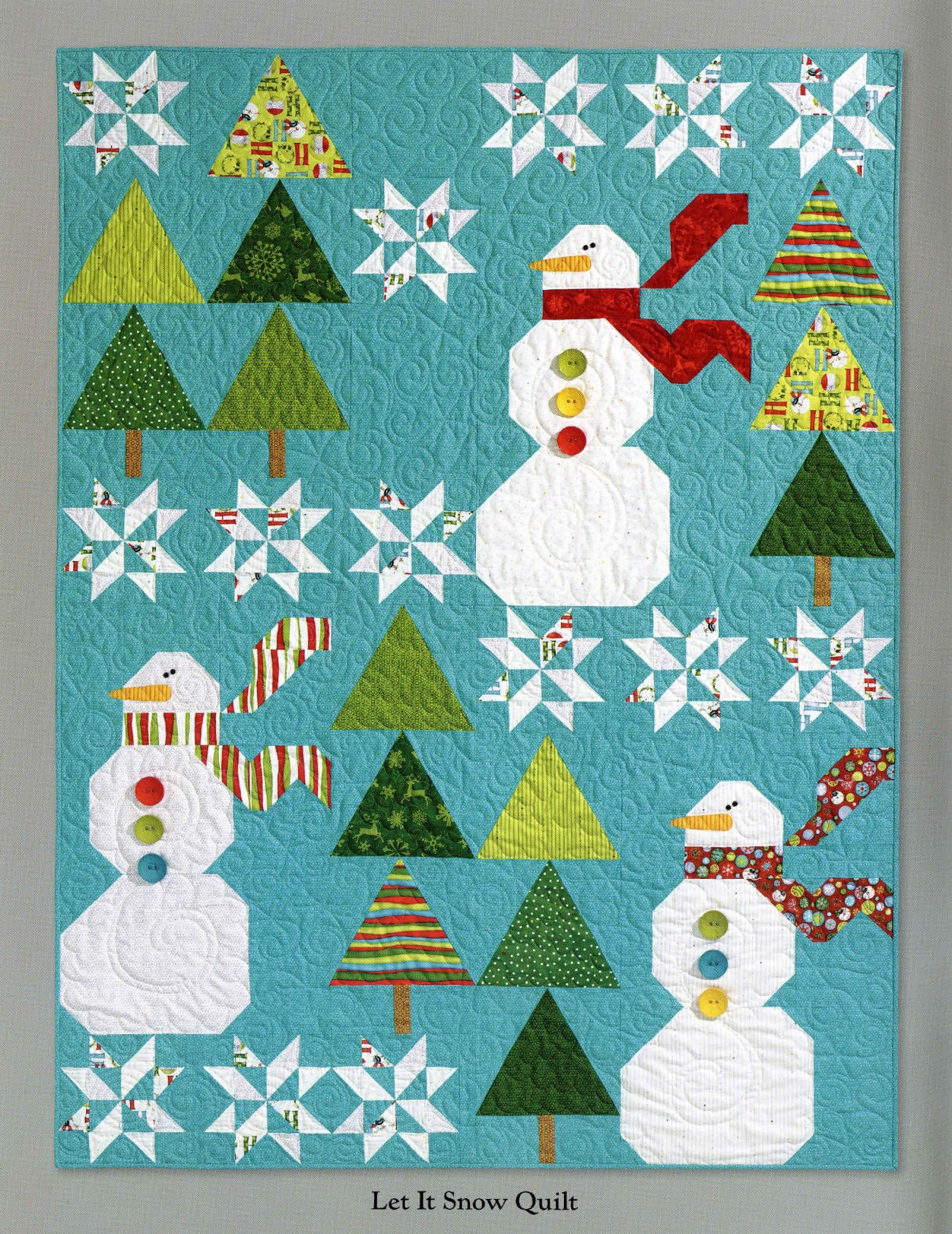 Interior page of the Ho Ho Ho Let It Snow quilt pattern book by Nancy Halvorsen of Art to Heart, showing the Let It Snow Quilt with appliqued snowmen, pieced trees, and snowflakes on a blue background.