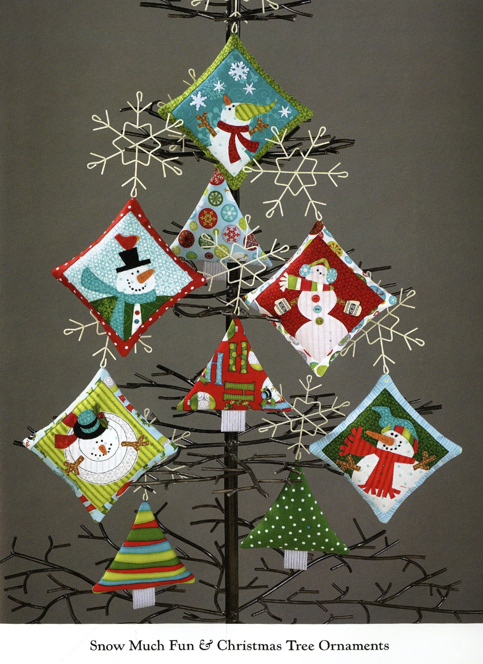Interior page of the Ho Ho Ho Let It Snow quilt pattern book by Nancy Halvorsen of Art to Heart, showing Snow Much Fun and Christmas Tree ornaments hung on a wire tree.