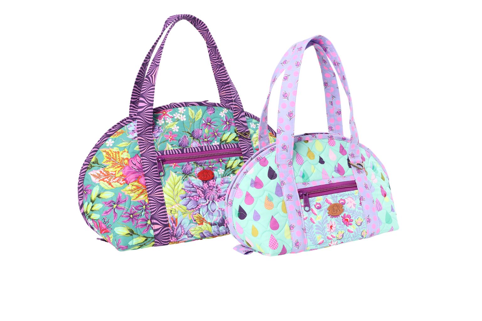 Two finished Hot and Heavy bags in a small and a large size shown closed, each with long handles and a front zippered pocket.