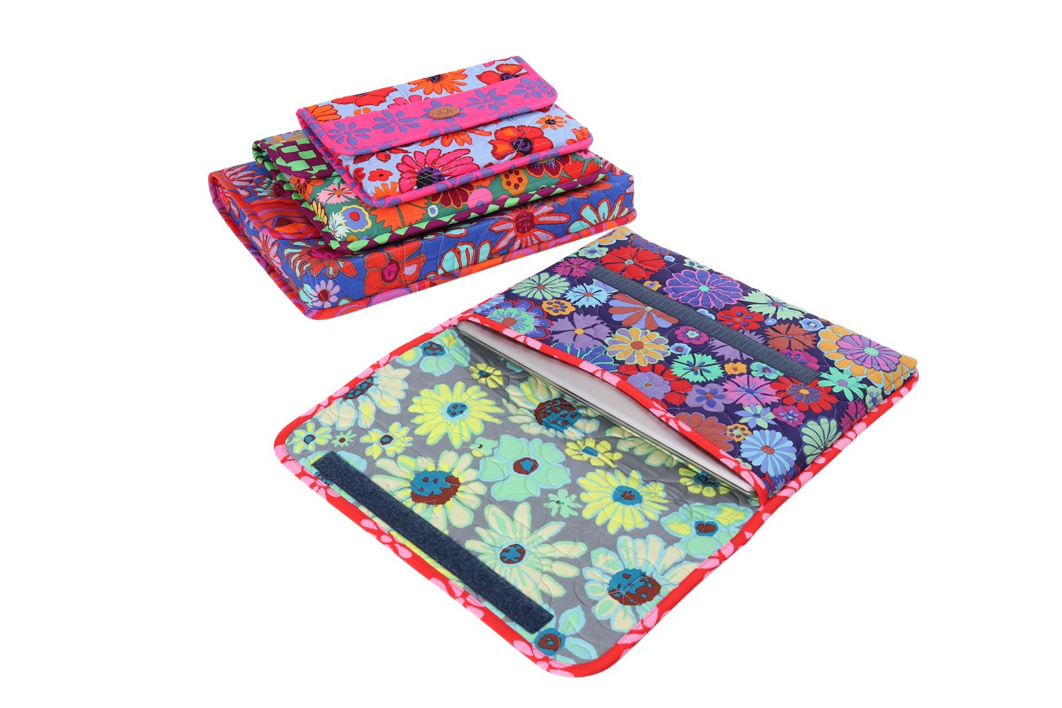 A stack of iCases cases in floral prints with one opened flat, showing the padded interior and the zippered pocket on the back.