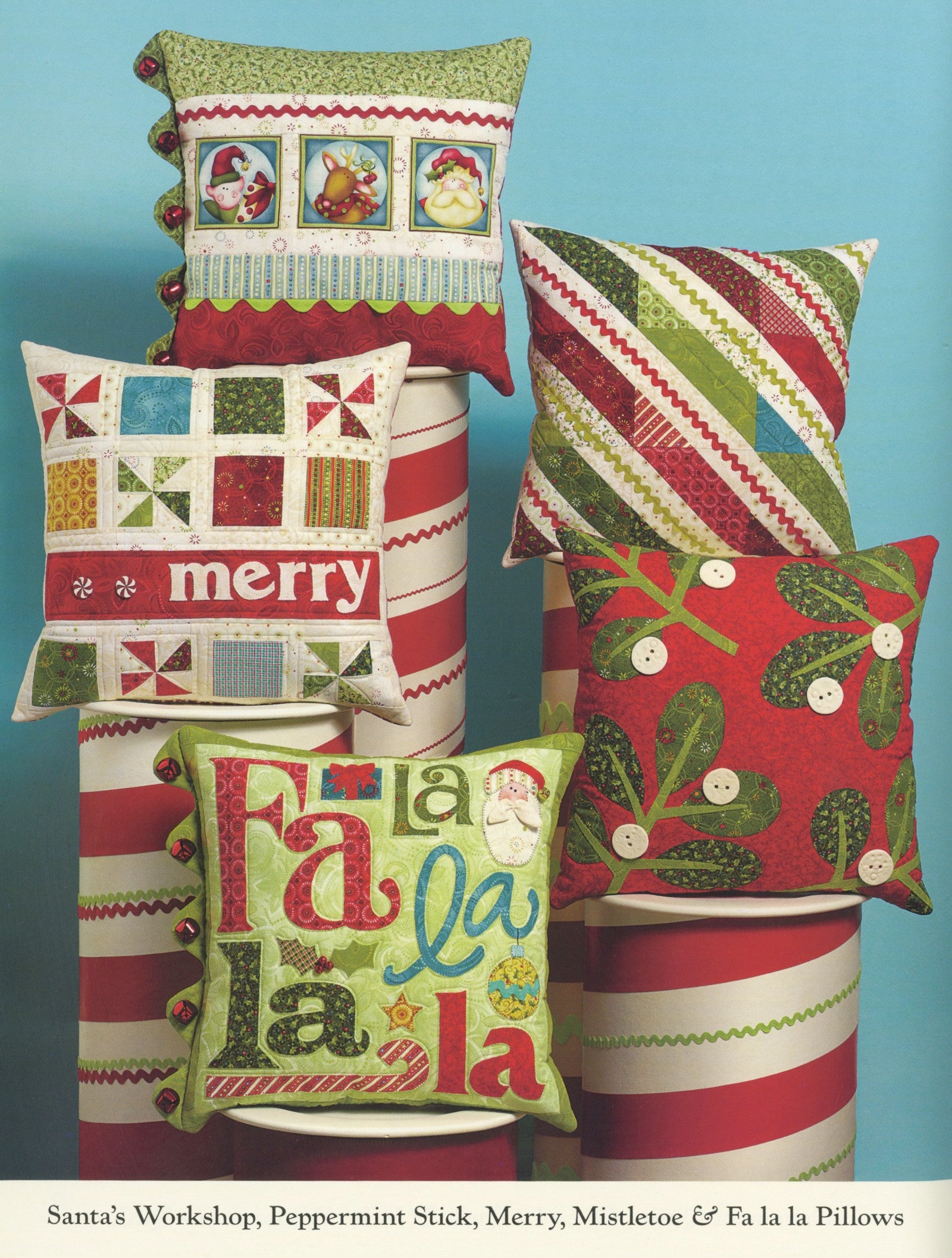 Interior page of the Jingle All The Way quilt pattern book by Nancy Halvorsen of Art to Heart, showing Santa's Workshop, Peppermint Stick, Merry, Mistletoe, and Fa la la pillows.
