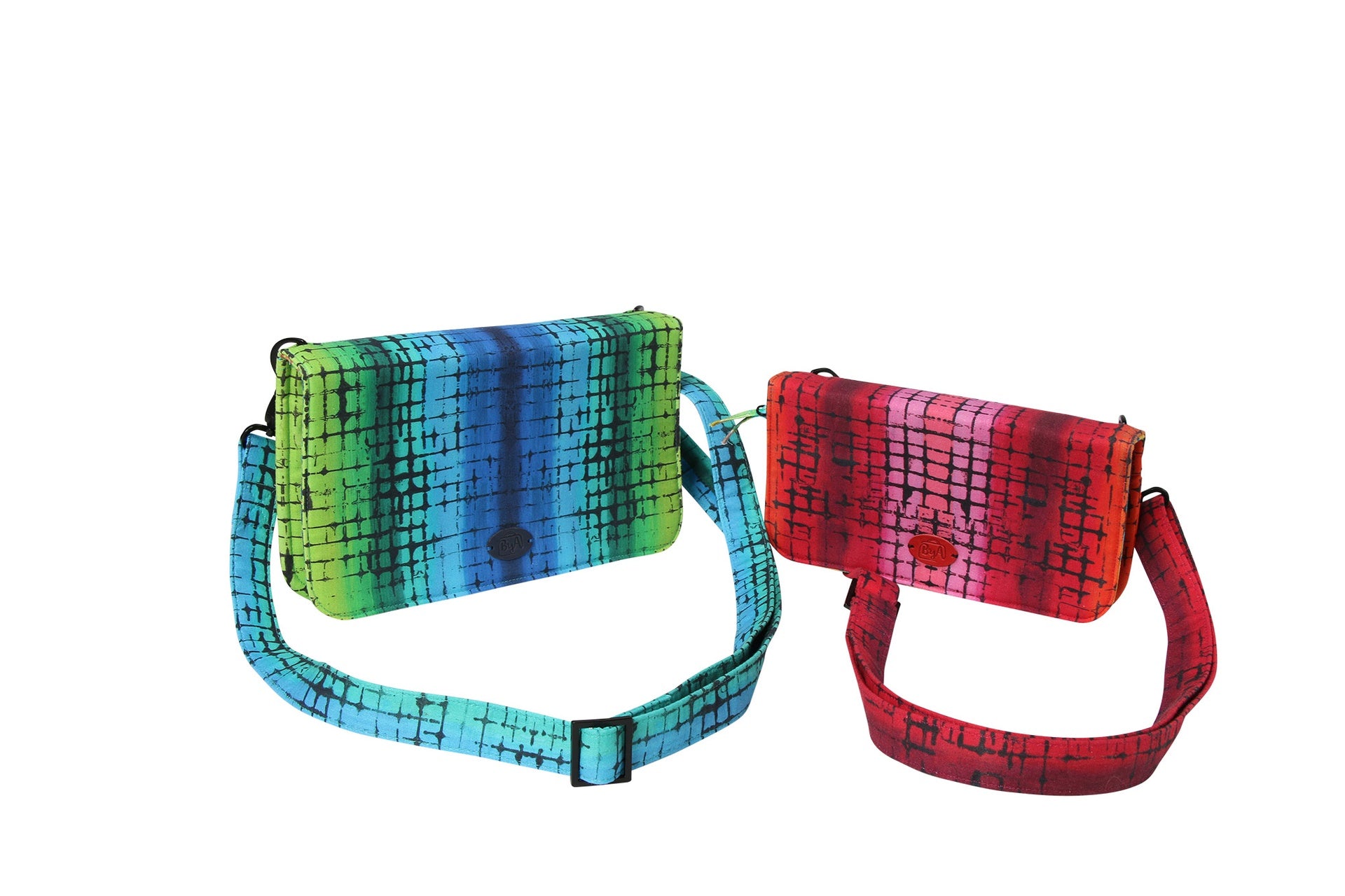 Two Payday wallets in rainbow and red prints with adjustable crossbody straps clipped on with swivel hooks.