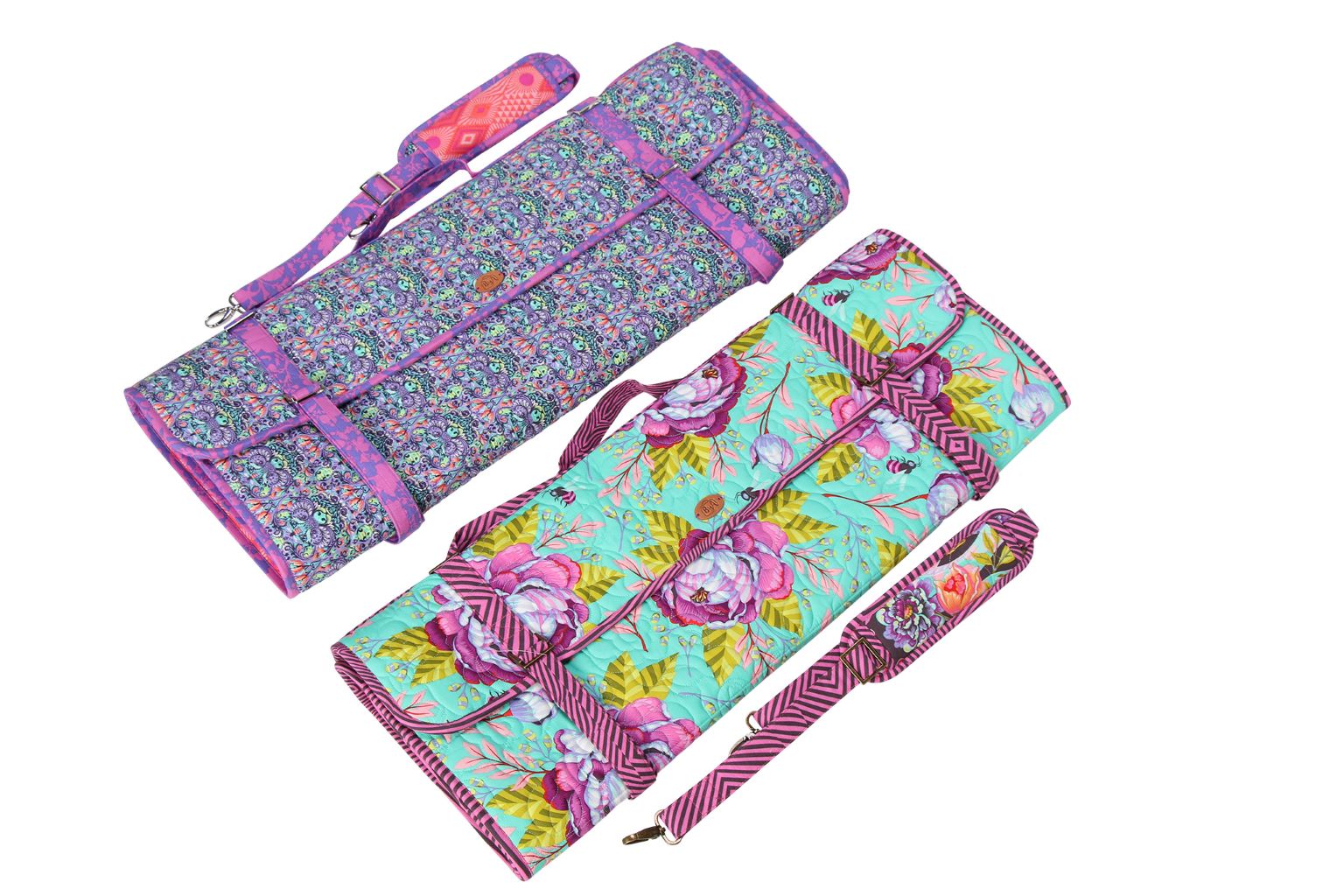 A Ruler Wrap rolled into a compact bundle next to a flat one, showing how it stores.