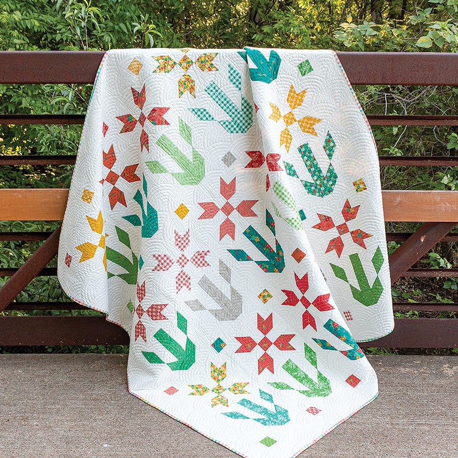Caramel Quilt from Simply Jelly Rolls, leaf and star motifs in warm prints on a white background.