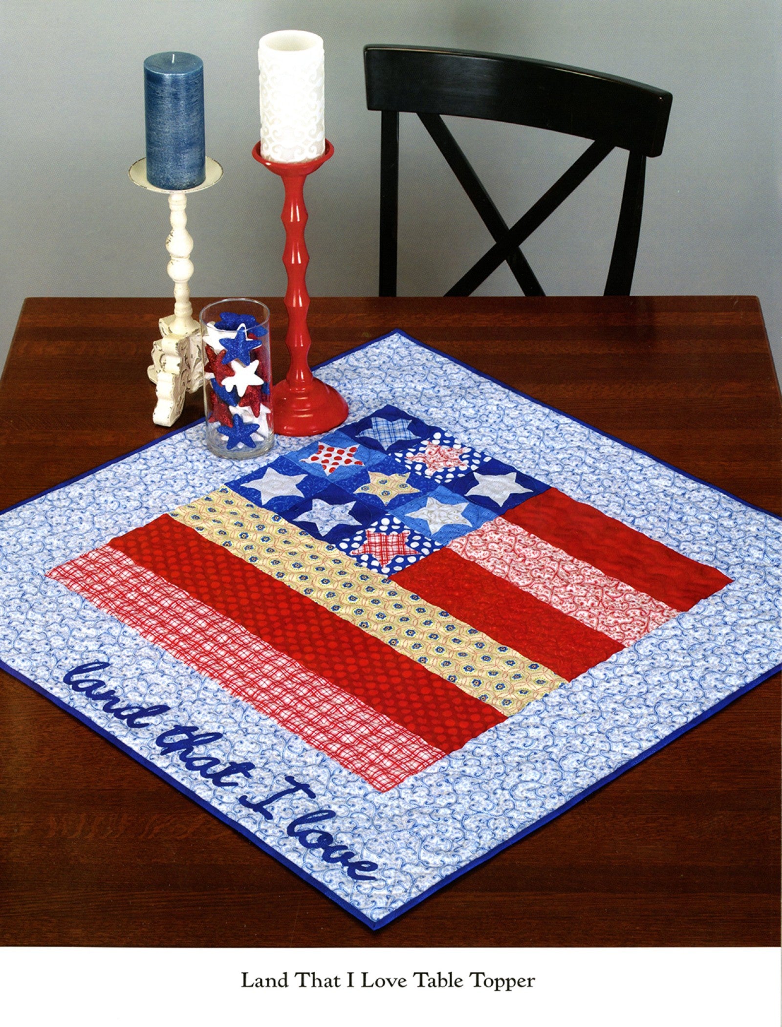 Interior page of the Table Please Part One quilt pattern book by Nancy Halvorsen of Art to Heart, showing the Land That I Love patriotic table topper with stars and stripes.