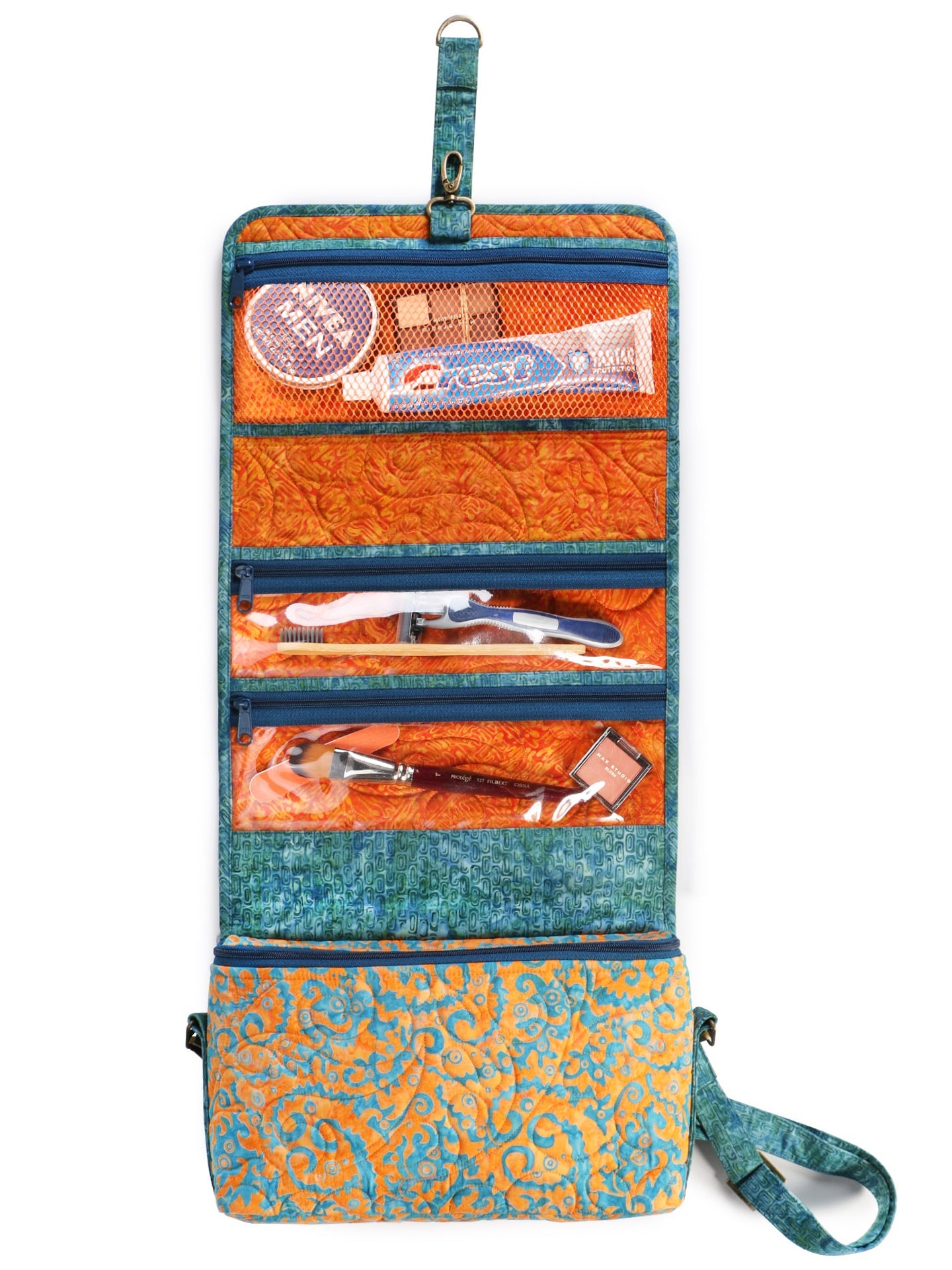 A Travel Essentials organizer hung open, showing rows of mesh and vinyl zippered pockets packed with toiletries.