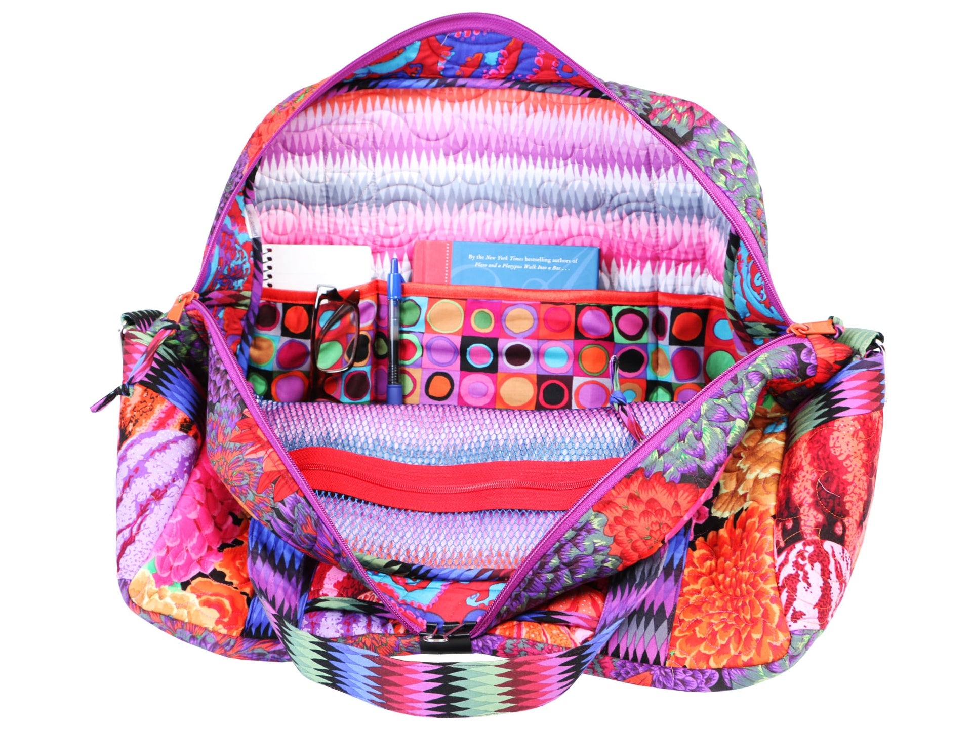 The Ultimate Travel Bag opened wide to show the interior packed with sewing notions and the full zippered pockets.