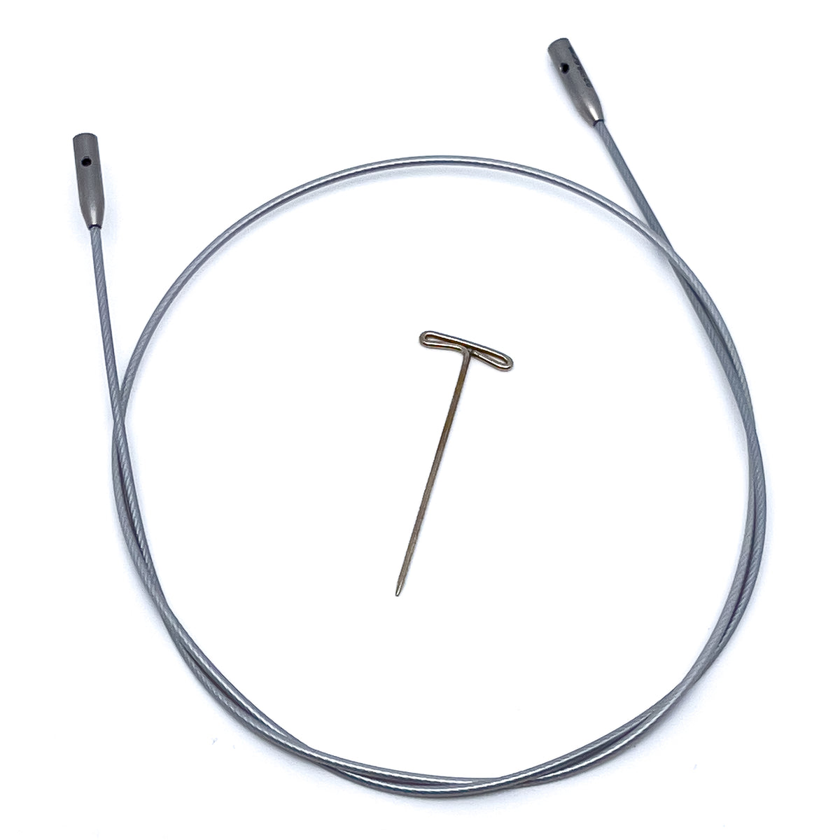 ChiaoGoo SWIV360 silver interchangeable knitting needle cable out of its package on a white background. The silver-gray nylon-coated cable lies in a loop with a gray metal join at each end, and a small hole shows in each join. A T-shaped metal tightening key lies in the center of the loop.