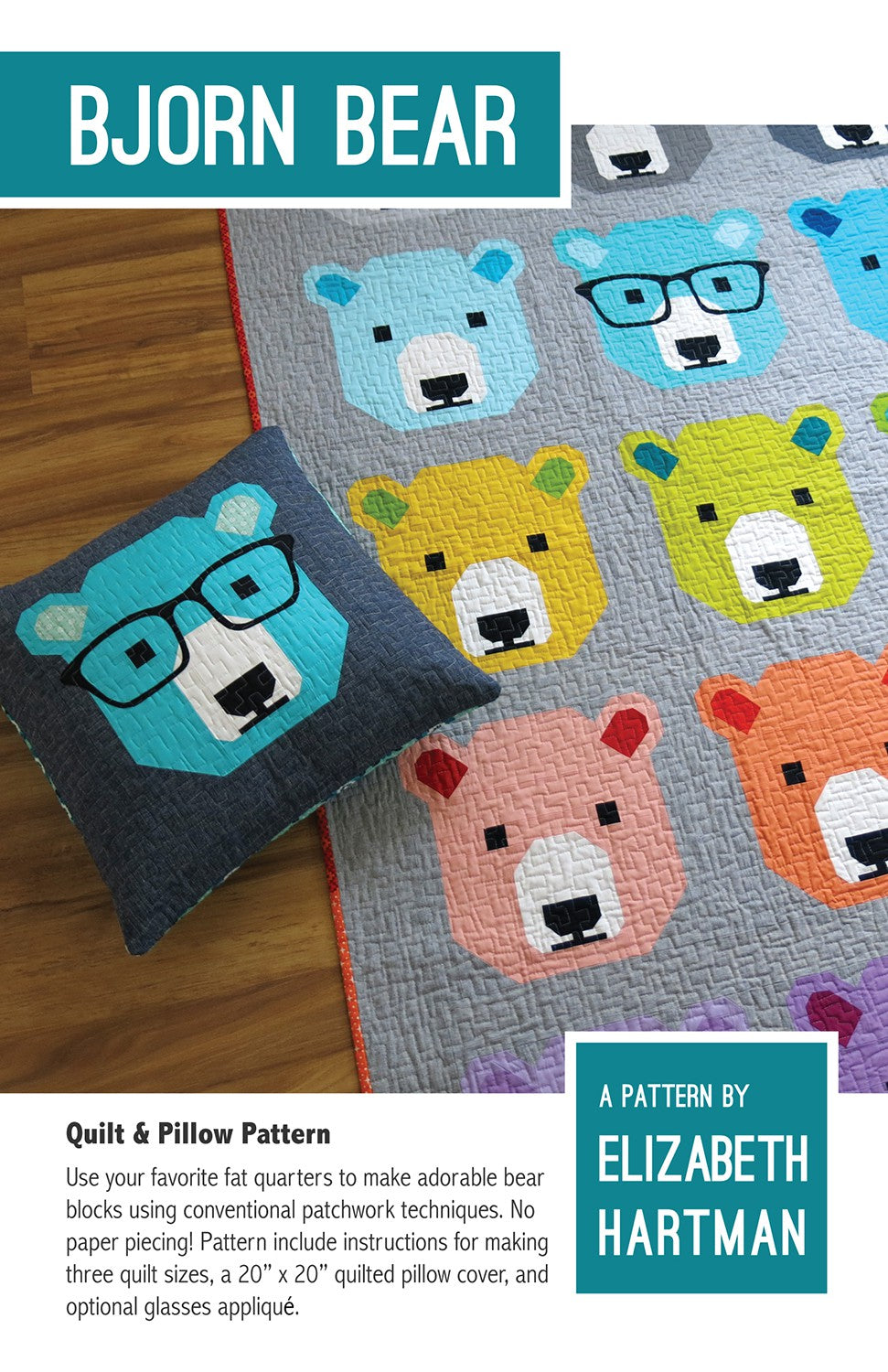 Bjorn Bear quilt pattern cover by Elizabeth Hartman. Quilt on a wood floor shows a grid of colorful patchwork bear faces in light blue, yellow, lime green, pink, orange, teal, and other colors on a gray background. A pillow in the foreground shows a single teal bear with optional patchwork glasses on a dark navy background.