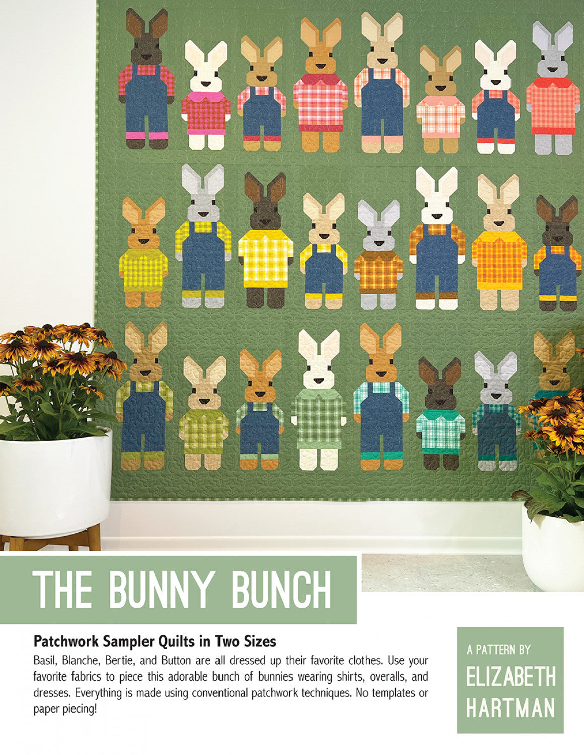 The Bunny Bunch quilt pattern cover by Elizabeth Hartman. Large 73 by 75 inch quilt hung on a wall between potted sunflowers shows 24 patchwork bunnies in three rows -- brown, tan, white, gray, and other colorways -- wearing plaid shirts, denim overalls, and dresses in a variety of colors on a sage green background.