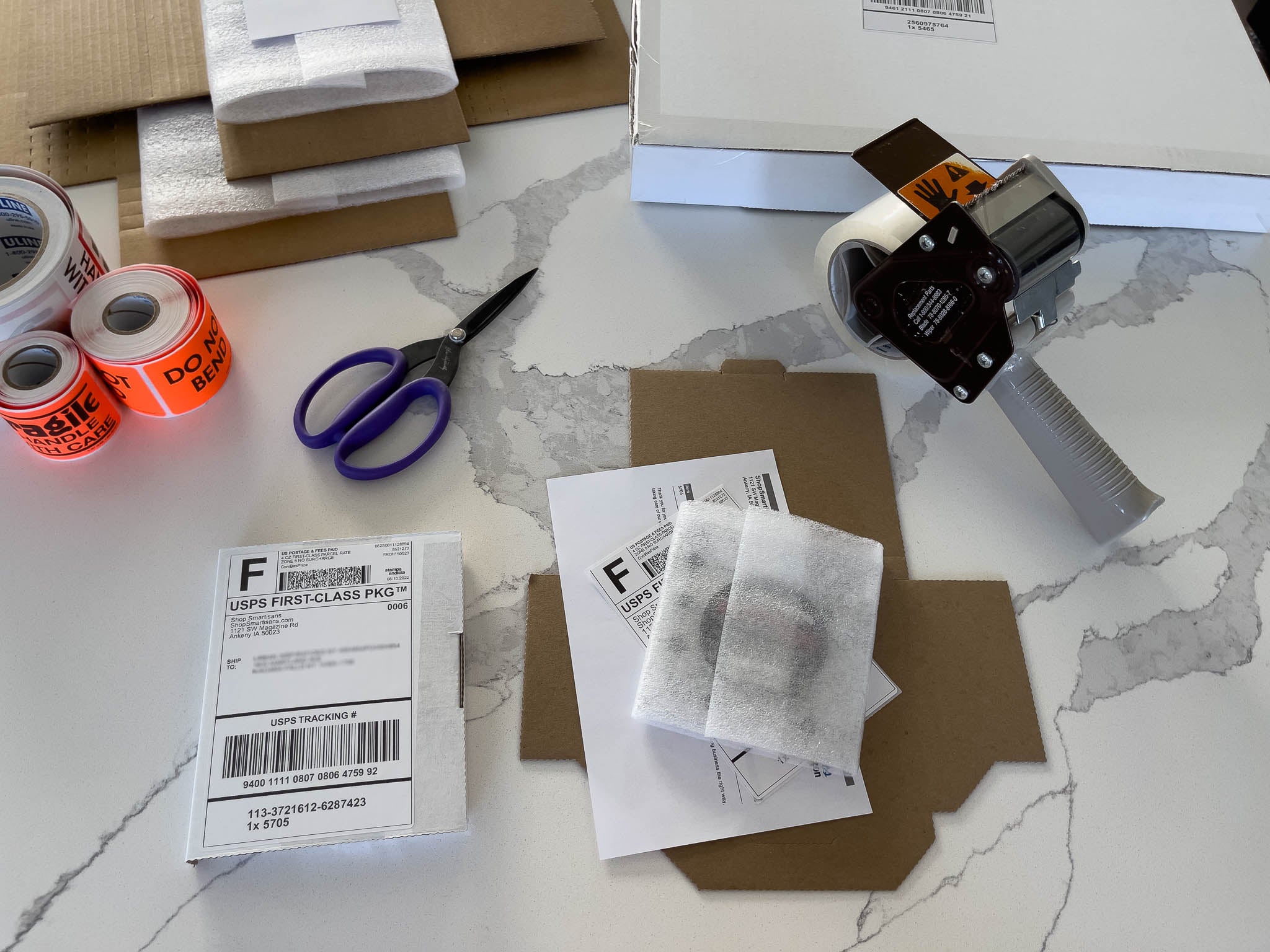 Smartisans shipments in progress, custom boxes, stickers, foam, scissors, packing tape