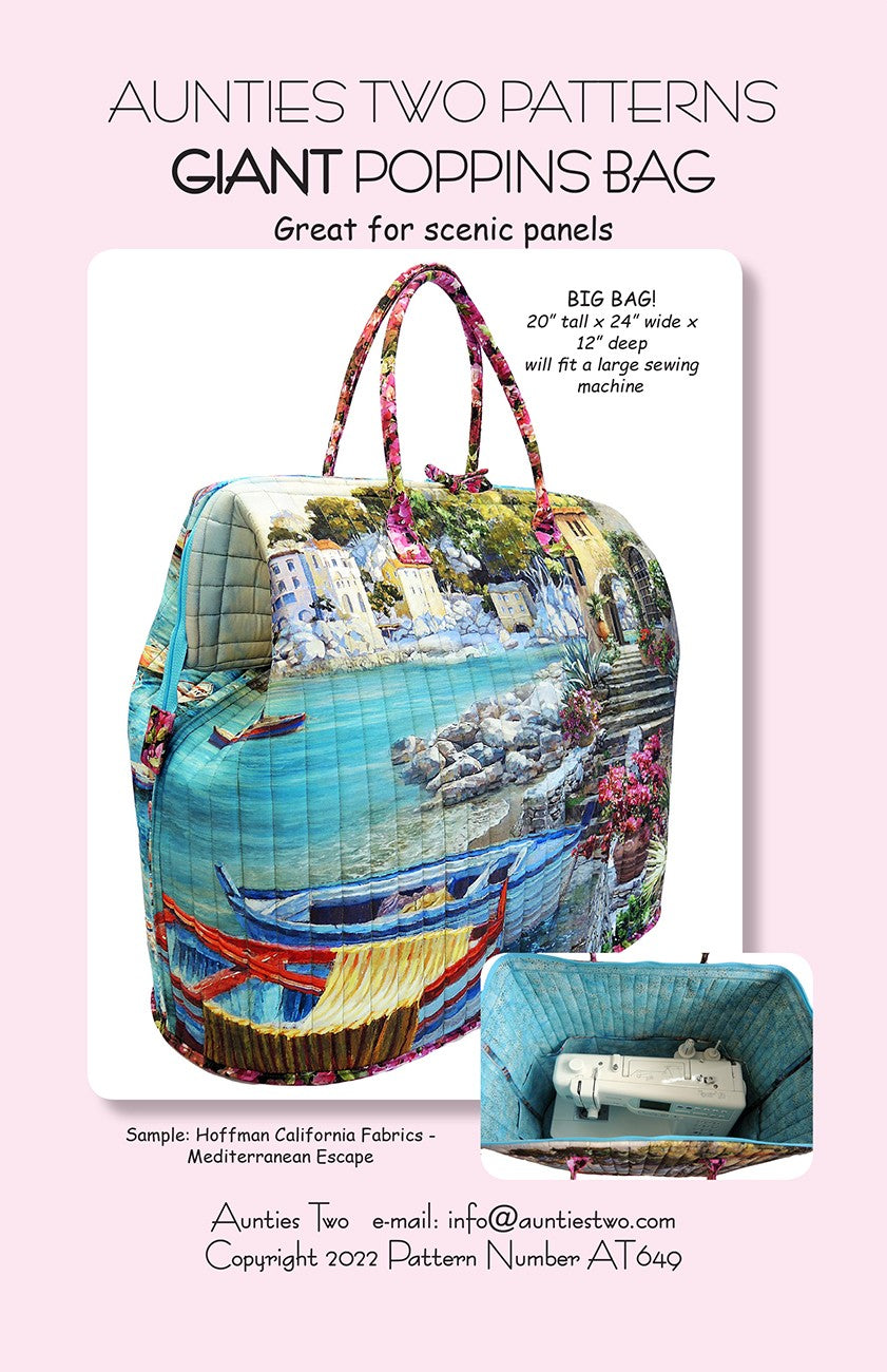 Aunties Two Patterns Giant Poppins Bag sewing pattern (AT649) front cover, which reads Great for scenic panels and Big bag, 20 inches tall by 24 inches wide by 12 inches deep, will fit a large sewing machine. The finished bag shows a Mediterranean harbor scene with boats and hillside houses, with pink floral handles, and an inset photo shows a sewing machine inside the open bag.