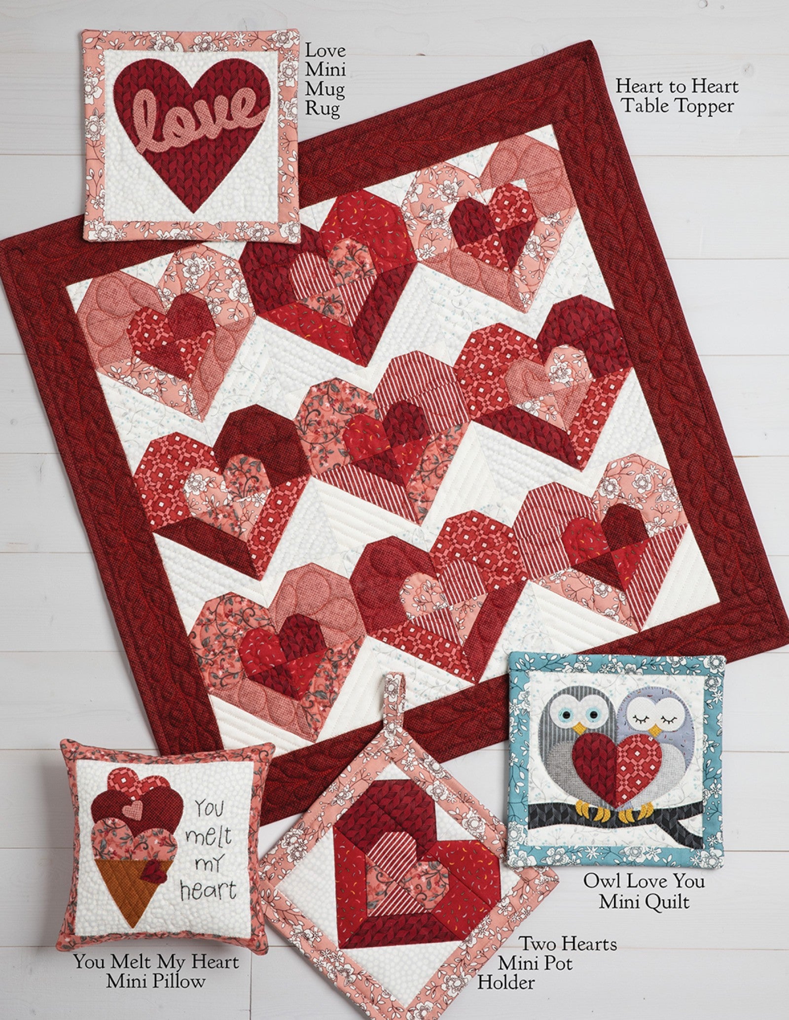 Interior page of the Loveland Cottage on Wander Lane pattern showing bonus projects such as a table topper, mini quilts, pot holder, pillows, and a mug rug.