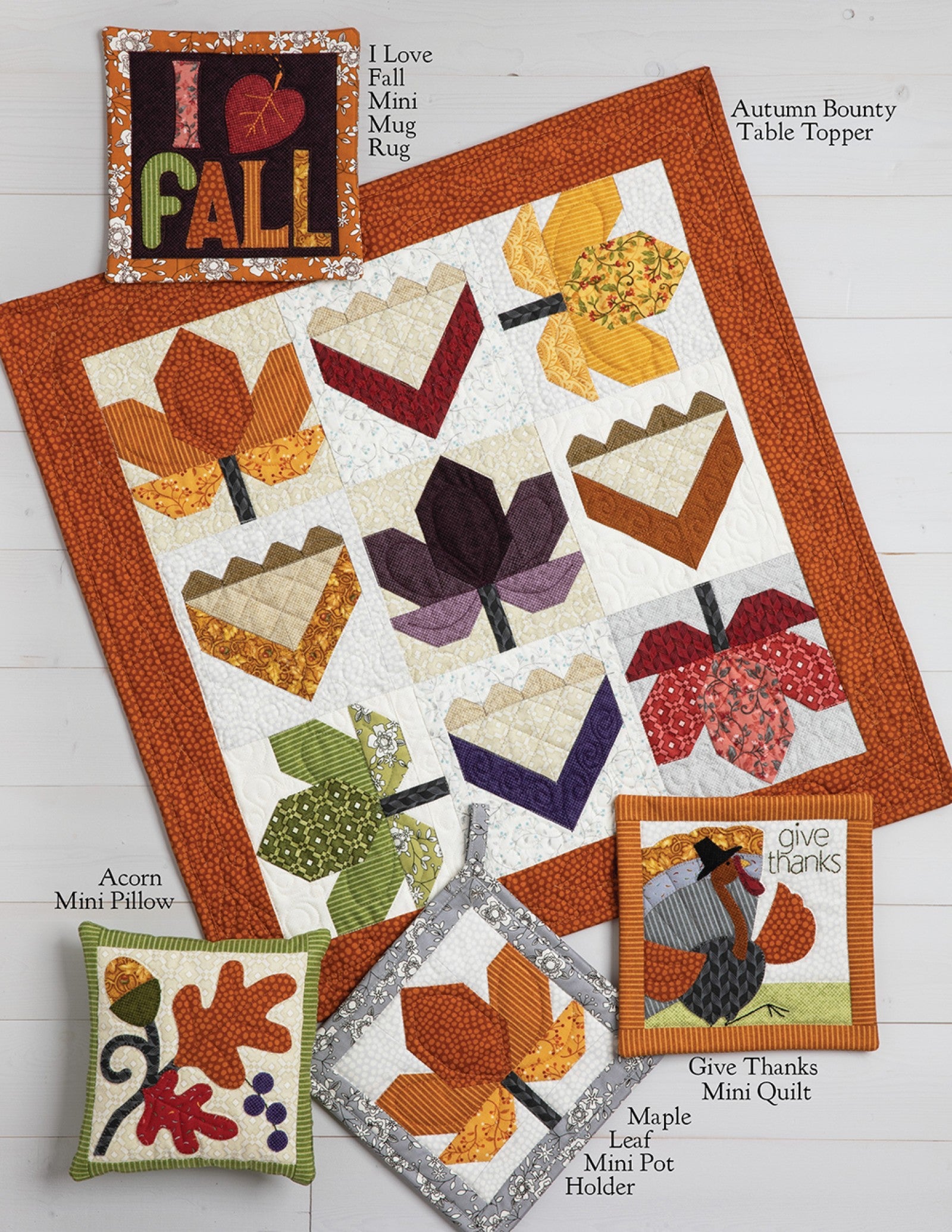Interior page of the Harvest Acres on Wander Lane pattern showing bonus projects such as a table topper, mini quilts, pot holder, pillows, and a mug rug.