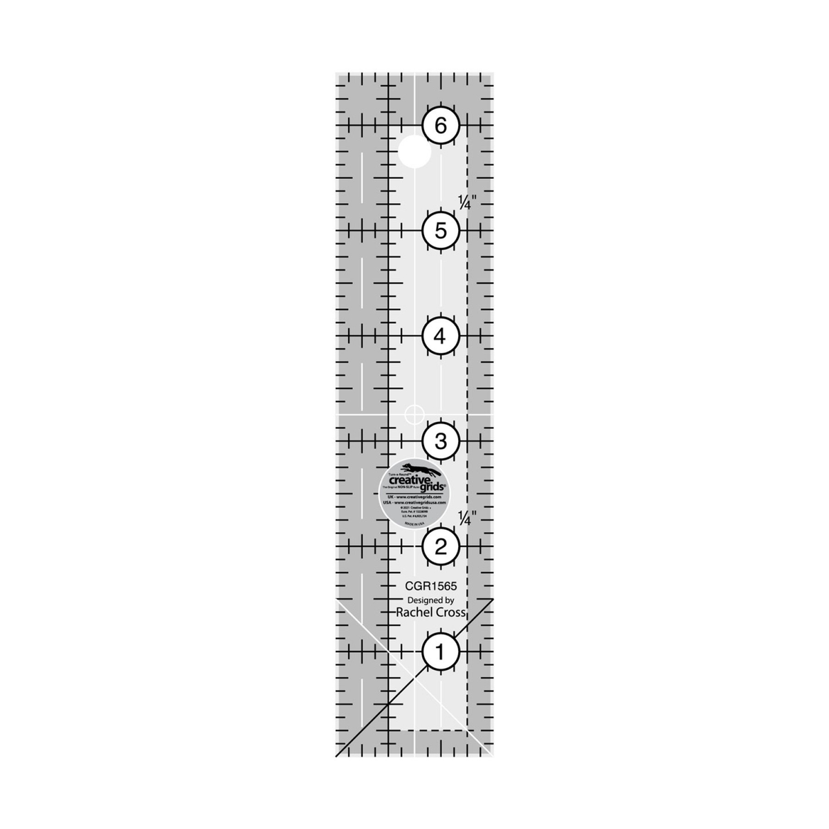 Creative Grids 1-1/2 x 6-1/2 inch rectangle quilt ruler CGR1565 by Rachel Cross, grayscale render on white: 1 inch grid with 1/8 inch tick marks, black numbers 1 to 6 in white dots along the length, white quarter-inch dashes across the width, a 1/4 inch dashed seam line inside one long edge and across one end, a black and a white 45 degree line crossing at one end, white centering lines, a hanging hole, and the Creative Grids non-slip logo circle.