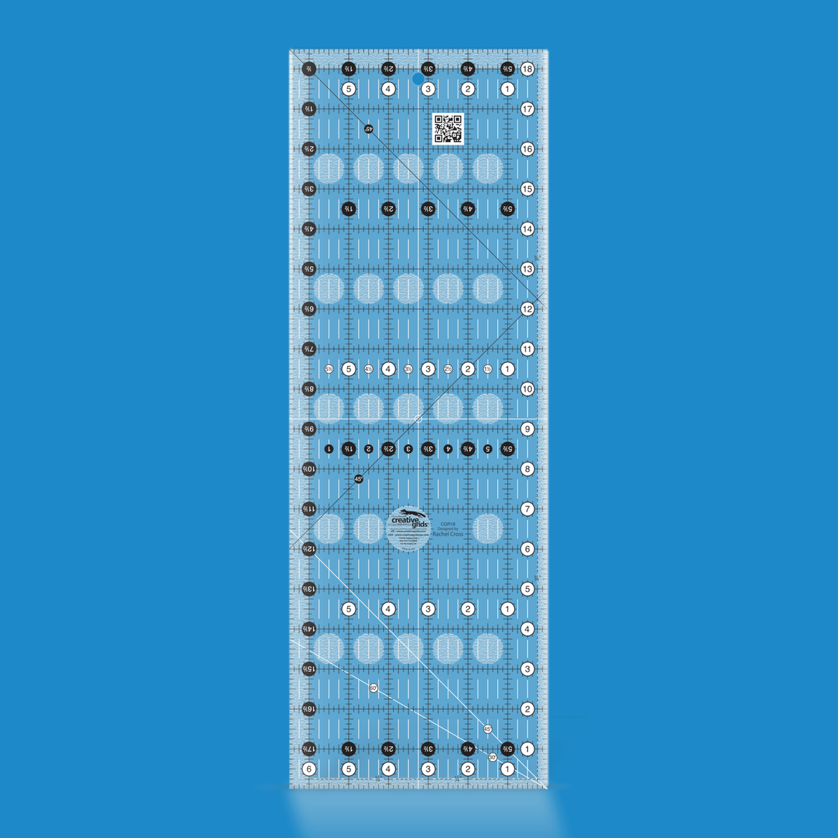 Creative Grids 6-1/2 x 18-1/2 inch rectangle quilt ruler CGR18 by Rachel Cross rendered in translucent blue acrylic with black and white grid markings, whole-inch numbers in white dots, half-inch Turn-a-Round numbers in black dots, crossed 45 degree lines, a 30/60 degree line, a 1/4 inch dashed seam line, and white centering lines.