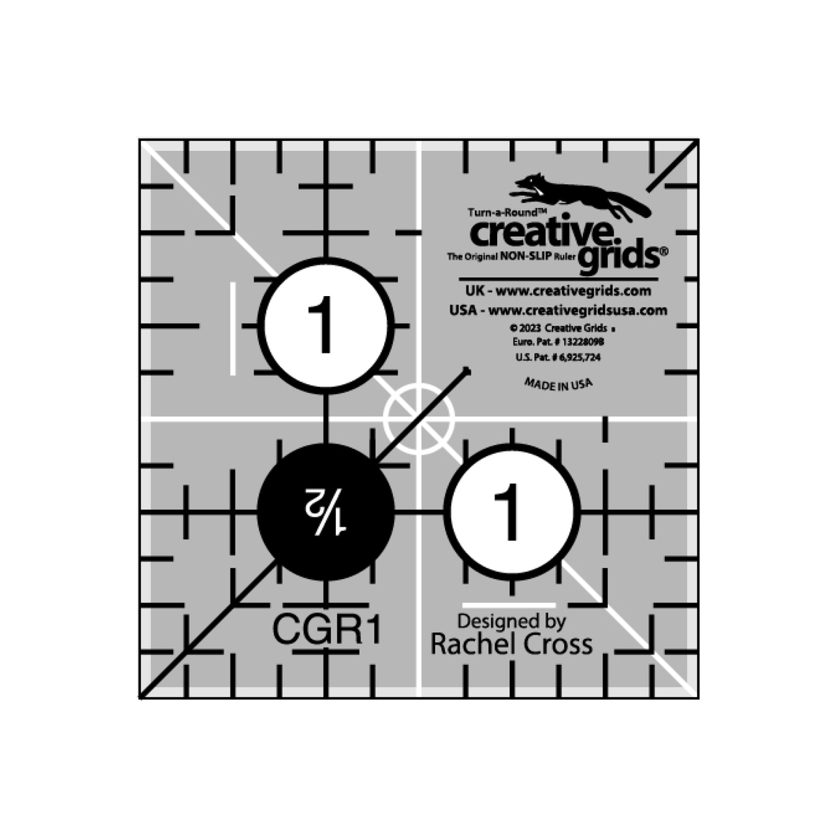 Creative Grids 1-1/2 inch square quilt ruler CGR1 by Rachel Cross, grayscale render on white: one 1 inch grid line each way with 1/8 inch tick marks, two black 1s in white dots, a white 1/2 Turn-a-Round number in a black dot, white and black 45 degree lines crossing at the center, white centering lines, and the Creative Grids non-slip logo block marked Made in USA.