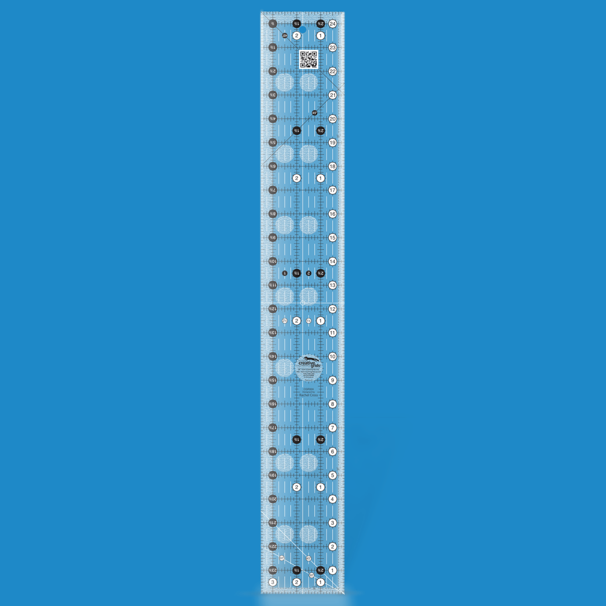 Creative Grids 3-1/2 x 24-1/2 inch rectangle quilt ruler CGR324 by Rachel Cross rendered in translucent blue acrylic with black and white grid markings, whole-inch numbers in white dots, half-inch Turn-a-Round numbers in black dots, crossed 45 degree lines, a 30/60 degree line, a 1/4 inch dashed seam line, and white centering lines.