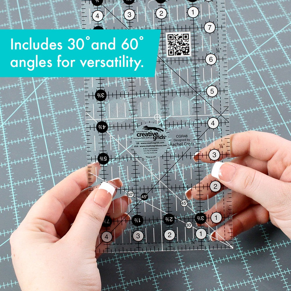 Hands holding the Creative Grids 4-1/2 x 8-1/2 inch ruler CGR48 over a gray cutting mat, with a brand caption about the 30 and 60 degree angles.