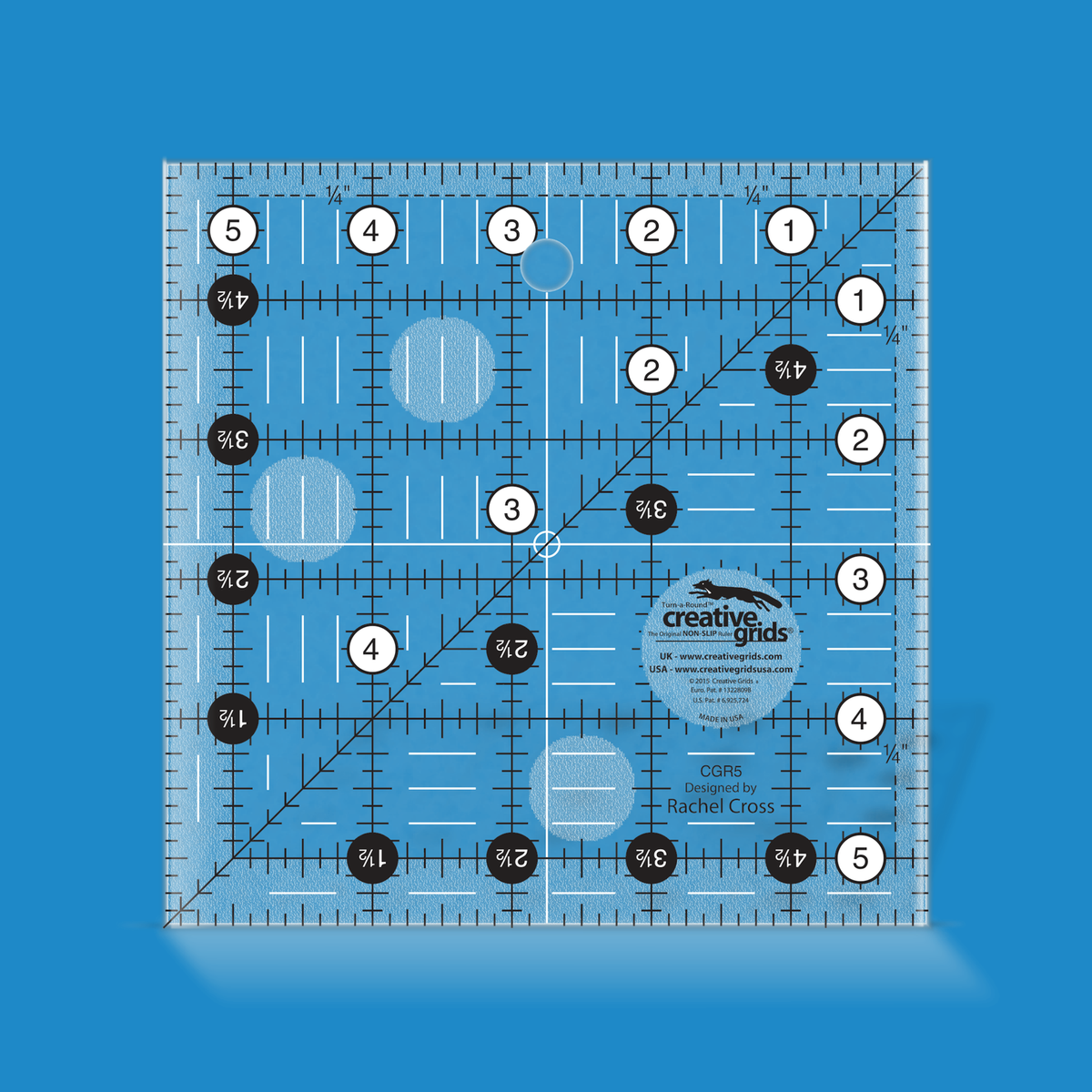 Creative Grids 5-1/2 inch square quilt ruler CGR5 by Rachel Cross rendered in translucent blue acrylic with black and white grid markings, whole-inch numbers in white dots, half-inch Turn-a-Round numbers in black dots, a 45 degree diagonal, a 1/4 inch dashed seam line, and white centering lines.