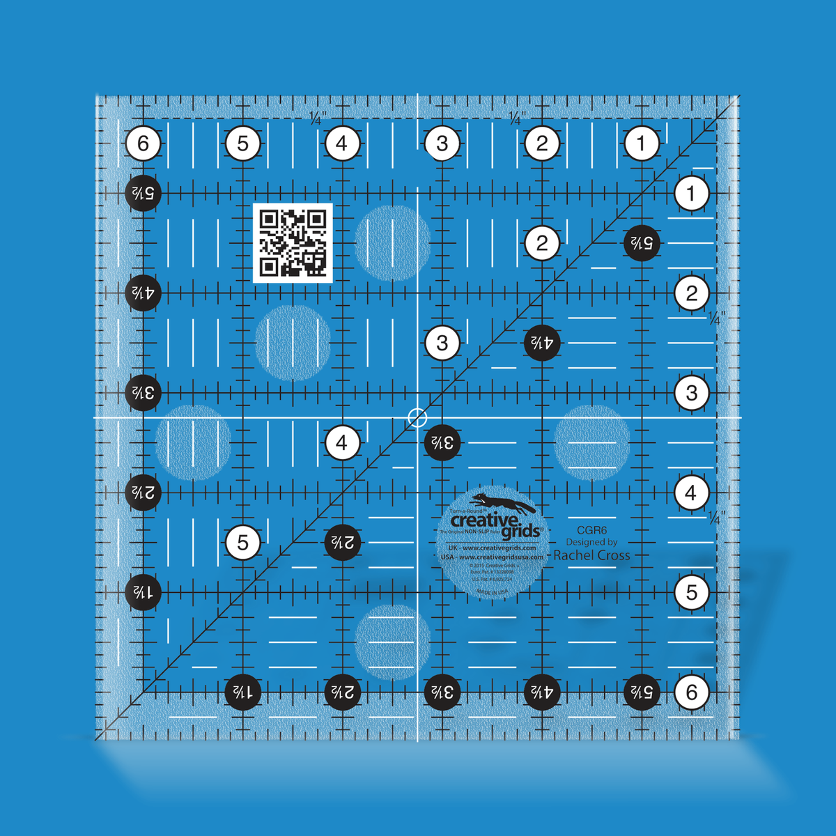 Creative Grids 6-1/2 inch square quilt ruler CGR6 by Rachel Cross rendered in translucent blue acrylic with black and white grid markings, whole-inch numbers in white dots, half-inch Turn-a-Round numbers in black dots, a 45 degree diagonal, a 1/4 inch dashed seam line, and white centering lines.