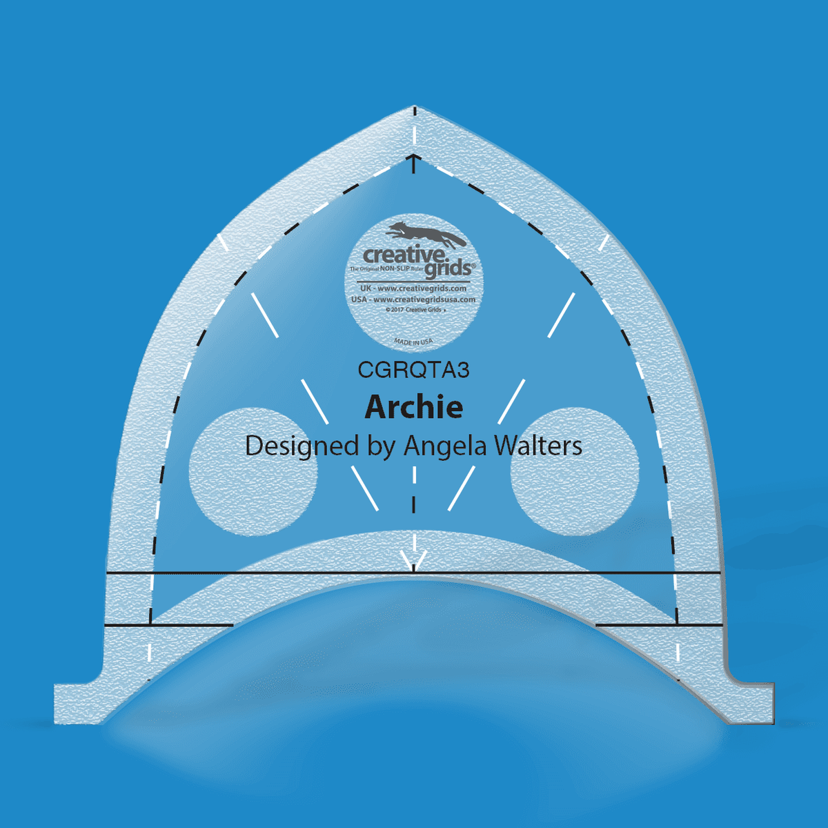 Creative Grids Archie Machine Quilting Ruler CGRQTA3 by Angela Walters in translucent blue acrylic with a black and white dashed line inside the pointed arch, a dashed center line with arrowheads, solid horizontal lines near the base, round grip pads, and the name Archie above the Designed by Angela Walters credit.