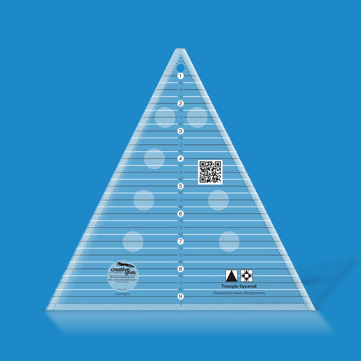 Creative Grids Triangle Squared Ruler CGRTMT2 by Karen Montgomery in translucent blue acrylic with horizontal lines every 1/4 inch numbered 1 to 9, dashed seam lines, a QR code, and triangle in a square and star block icons above the Designed by Karen Montgomery credit.