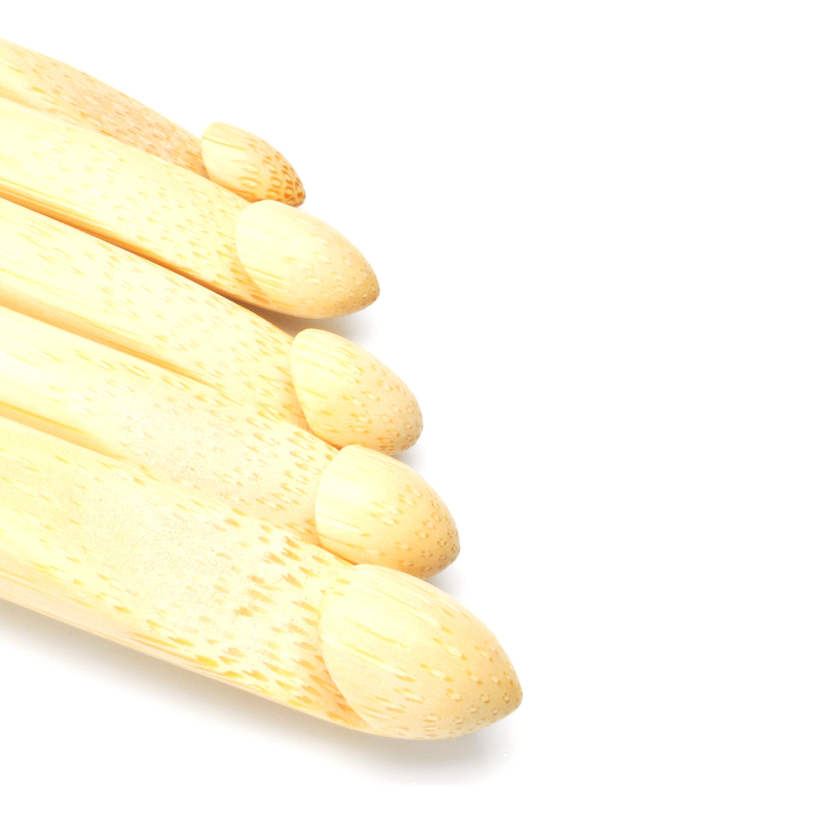 Close-up of the heads of ChiaoGoo bamboo crochet hooks in graduated sizes on a white background. Each pale bamboo head has a rounded tip, and the speckled grain of the bamboo shows on each one.