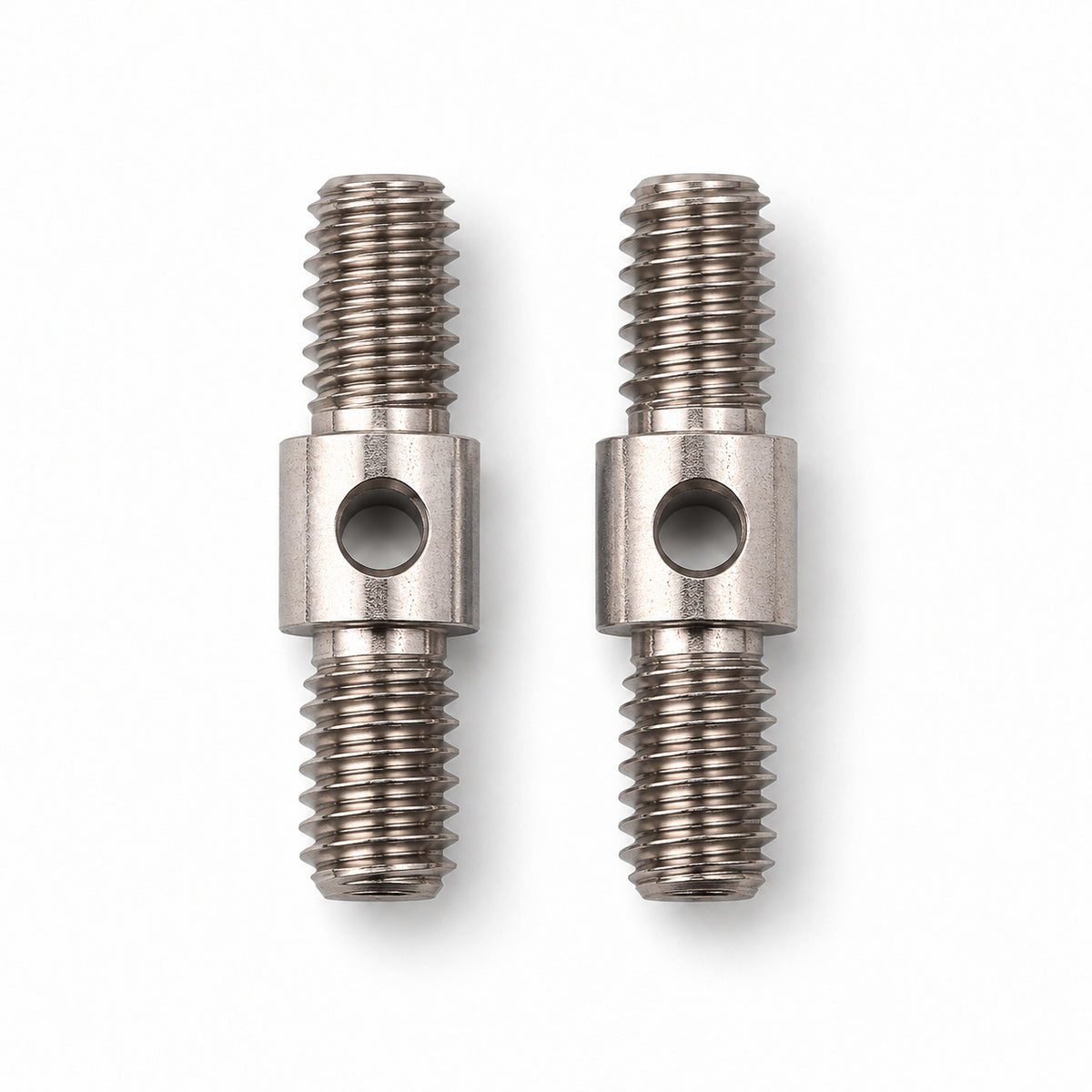 Two ChiaoGoo Large [L] cable connectors on a white background. Each steel connector has a threaded screw at both ends and a center collar with a round hole for the tightening key.