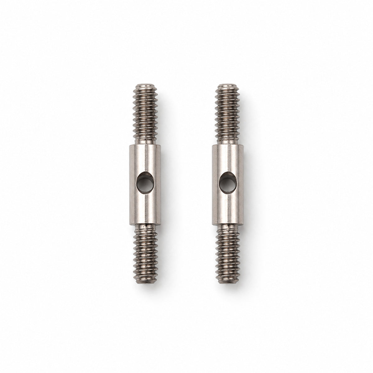Two ChiaoGoo Mini [M] cable connectors on a white background. Each steel connector has a threaded screw at both ends and a center collar with a round hole for the tightening key.