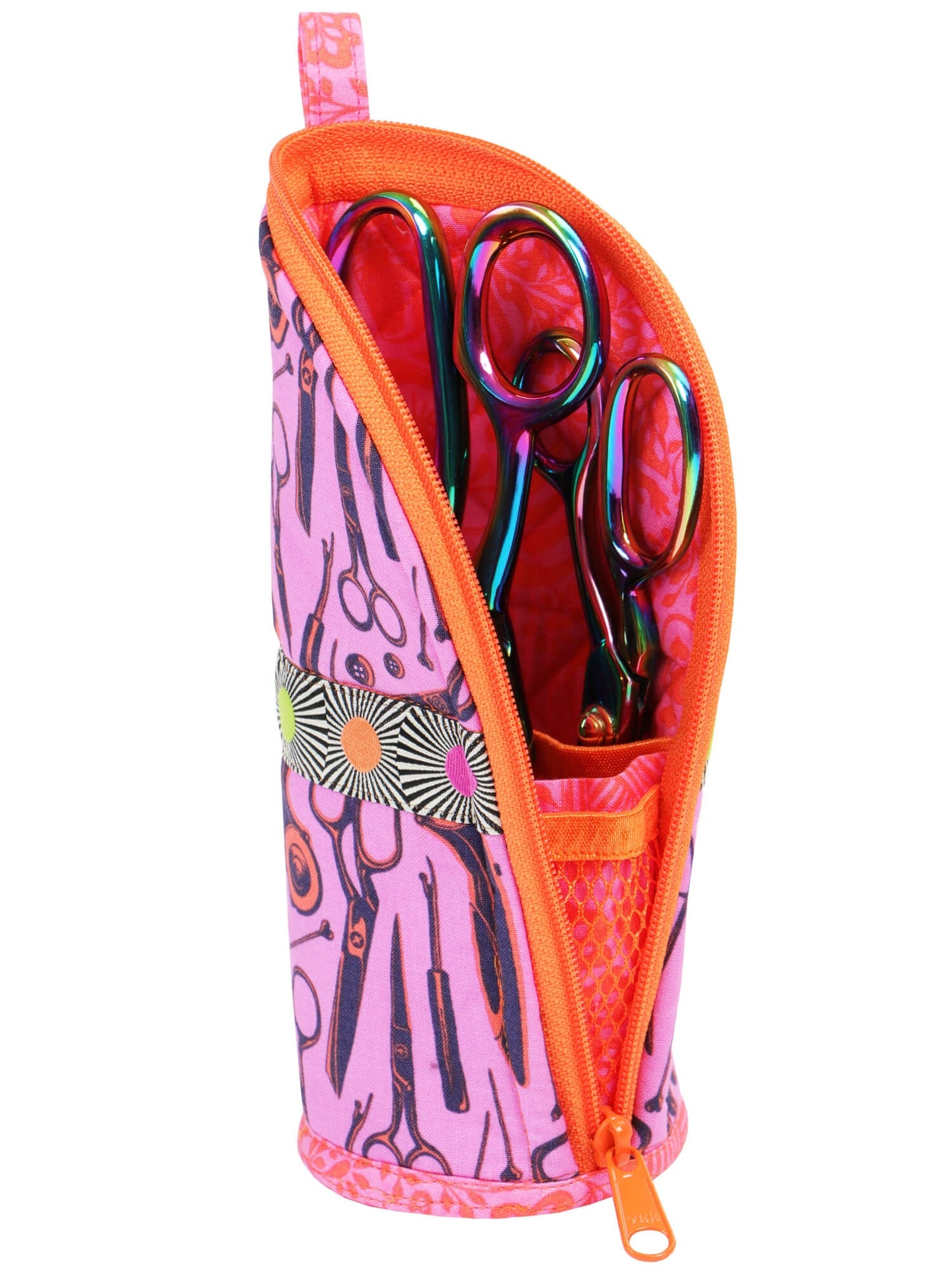 A pink and orange Flipping Out case folded open into a stand, holding scissors and pens upright.