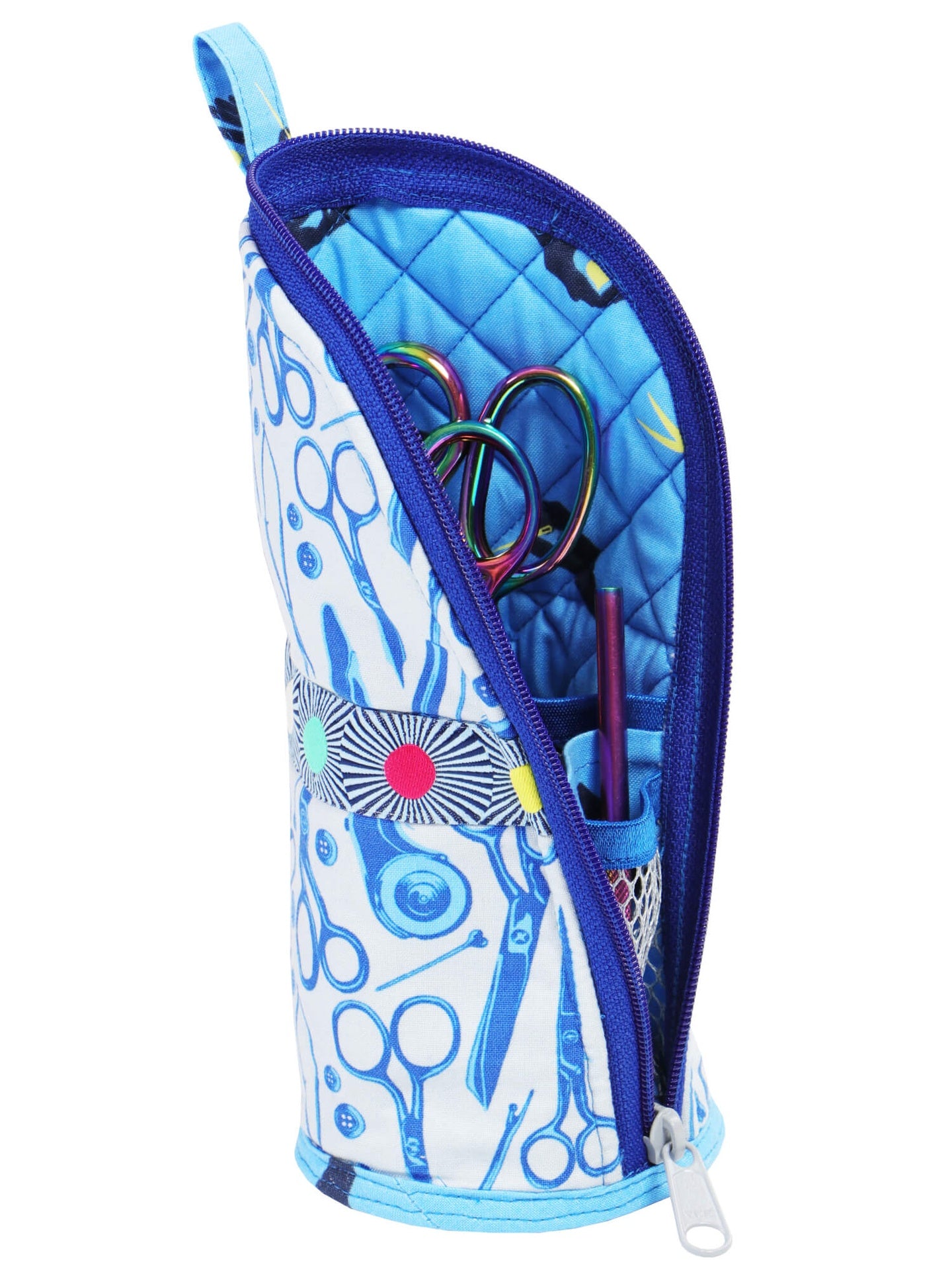 A Flipping Out case folded open into a desktop stand, holding marking pens and sewing tools in its mesh pockets.