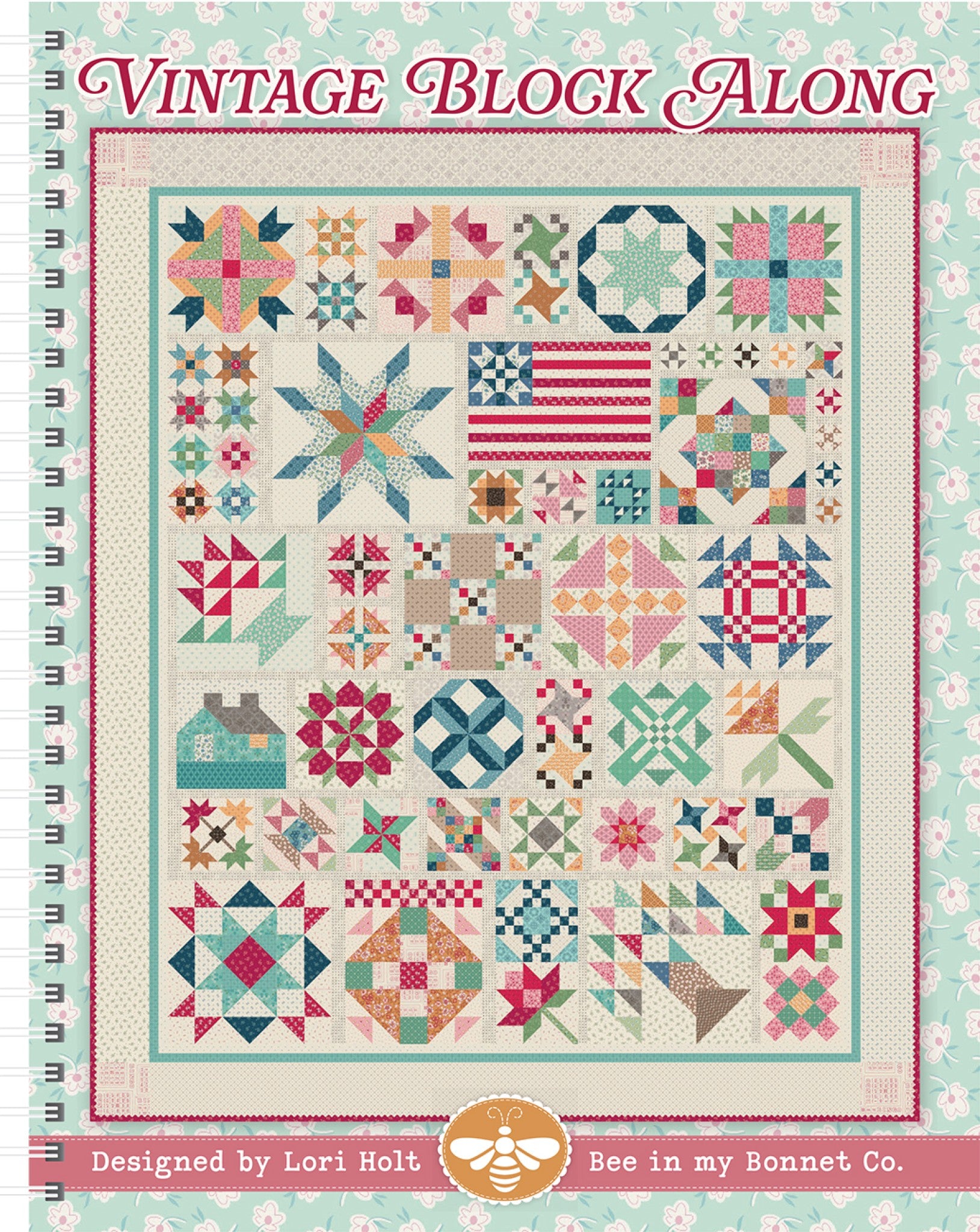 Front cover of Vintage Block Along quilt pattern book by Lori Holt for It's Sew Emma, a large spiral-bound sampler quilt of traditional pieced blocks including stars, baskets, a flag, and a house on a cream background with a floral border in vintage pinks, teals, reds, and golds.