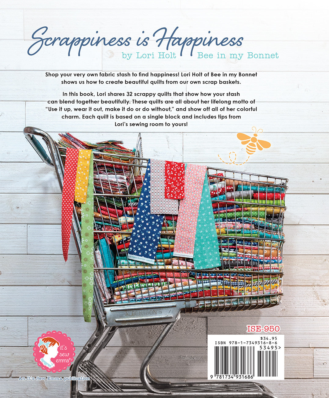 Back cover of Scrappiness is Happiness by Lori Holt for It's Sew Emma. A vintage shopping cart filled with folded scrappy quilts and draped fabric, with the book blurb, the It's Sew Emma logo, and item number ISE-950.
